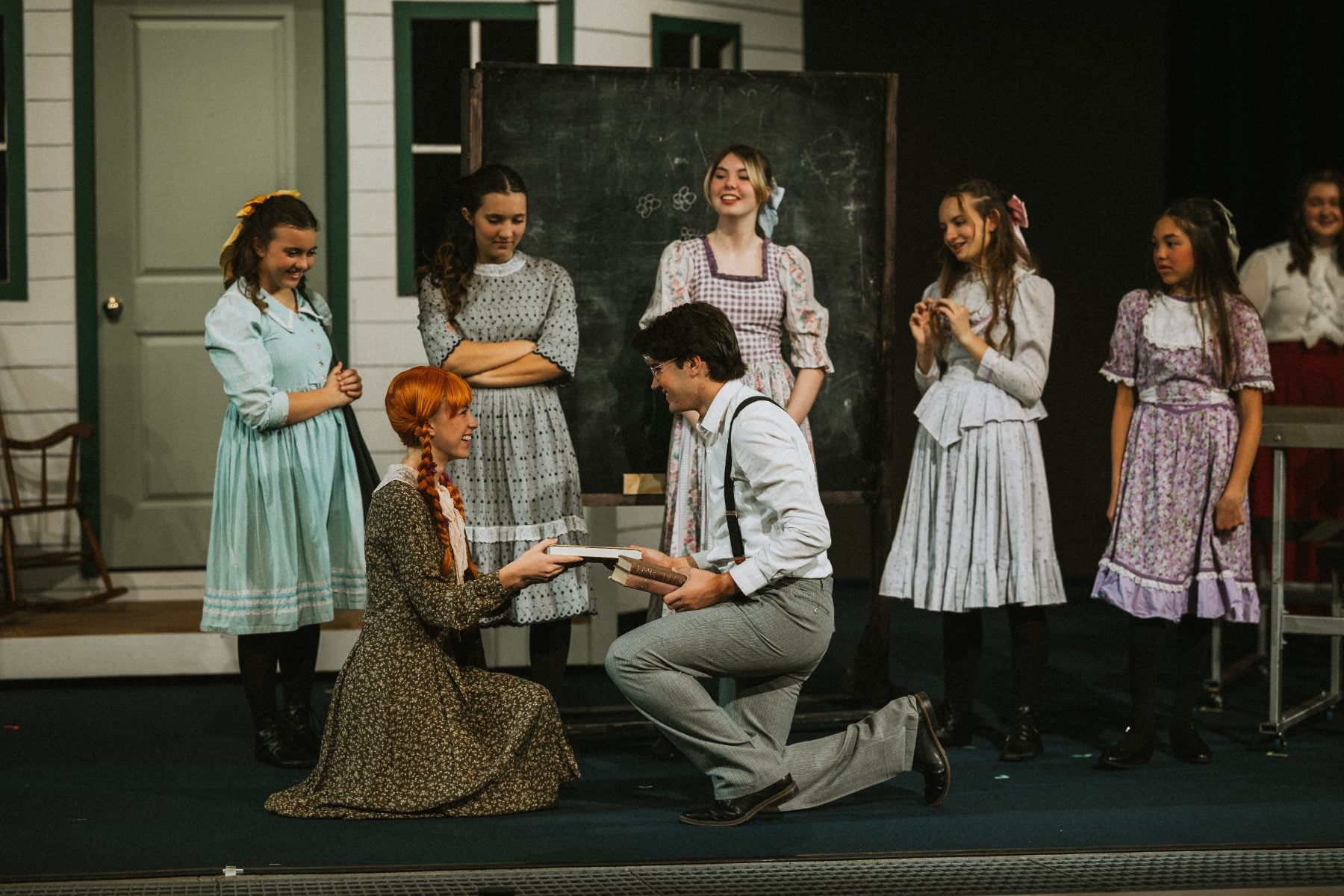 Cast members gather around kneeling actors during a tender scene at Shadow Mountain Event Center