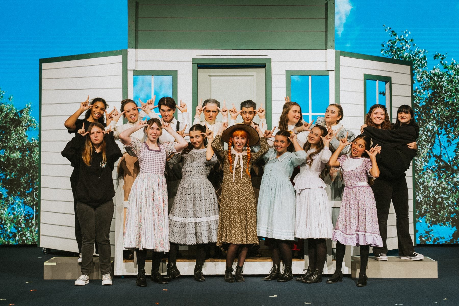 Full cast of the Christian school drama program strikes a pose onstage
