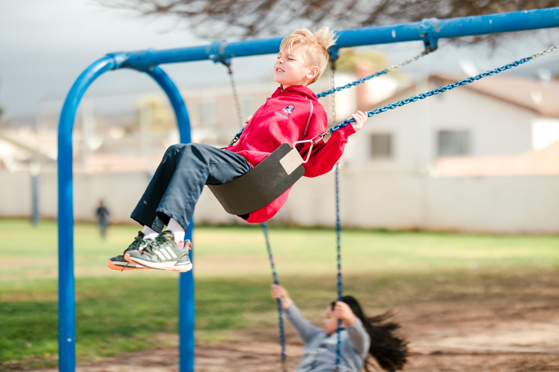A boy swings high on the playground at Christian Elementary School