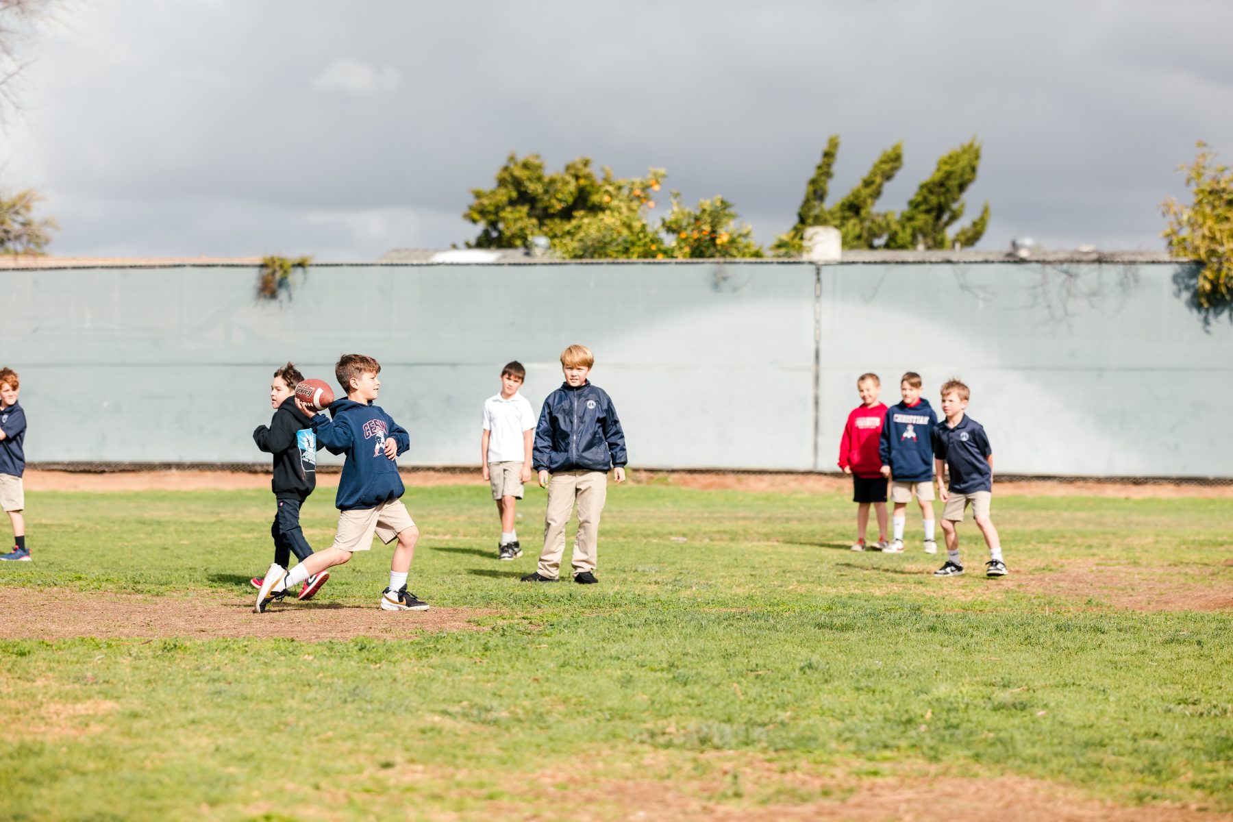 Students play baseball on the field during outdoor recess at recess
