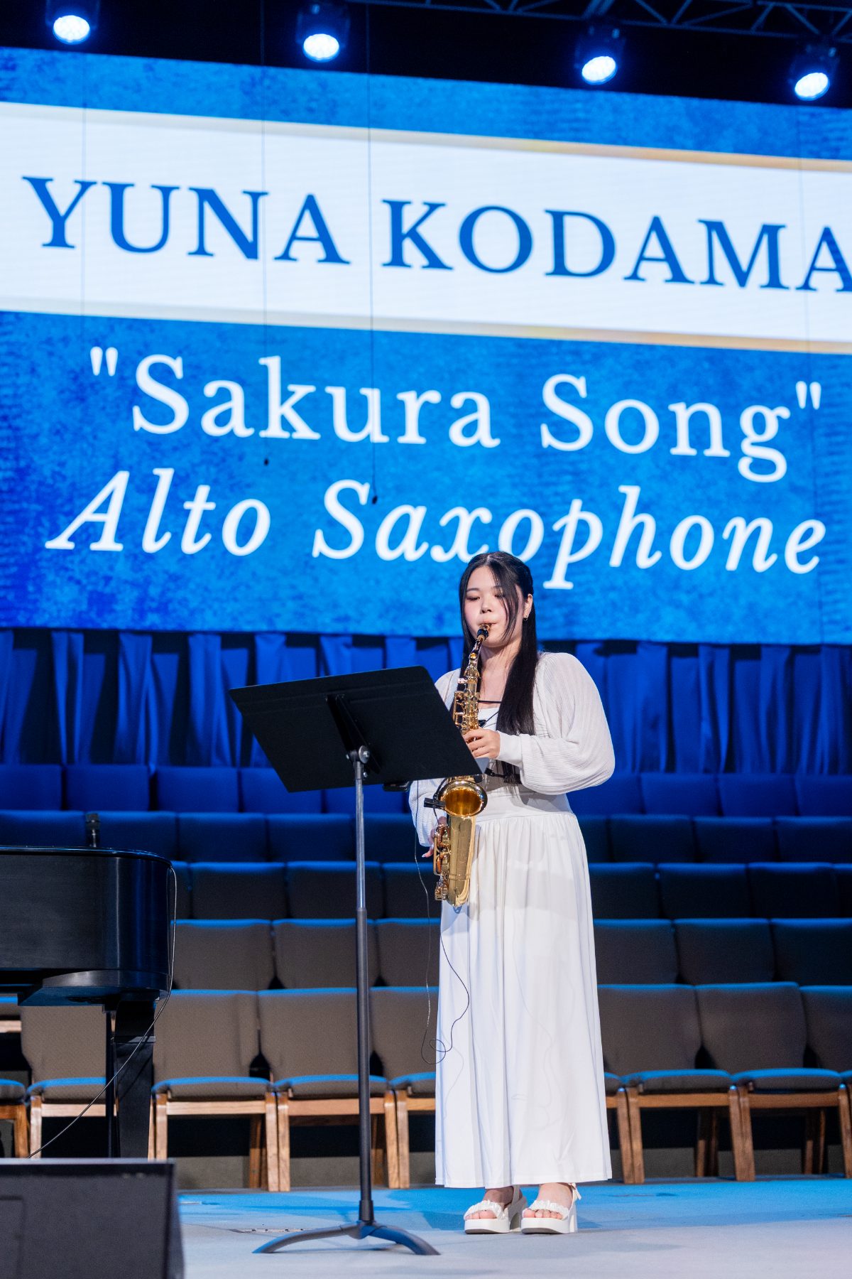 A student performs "Sakura Song" on alto saxophone at graduation