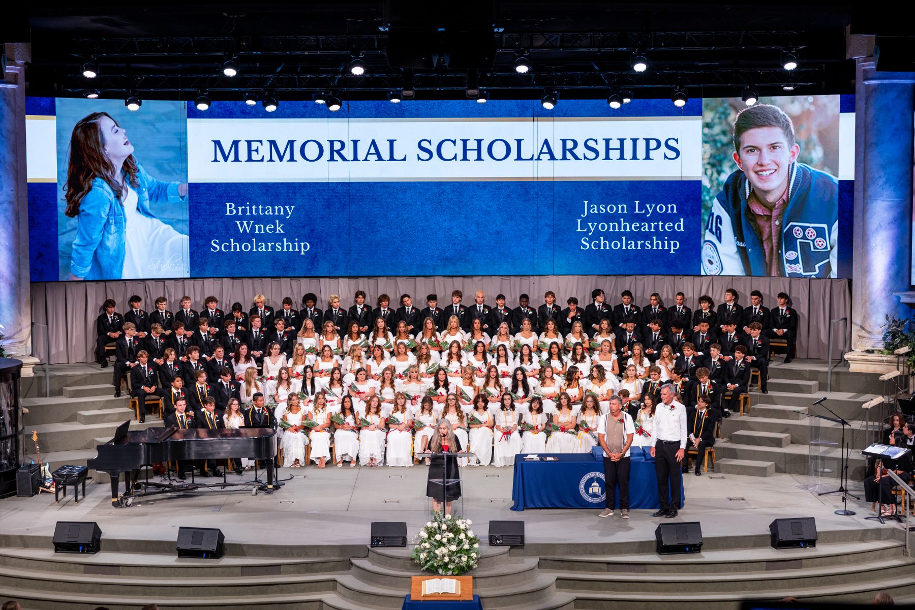 Graduates and choir on stage during Memorial Scholarships tribute at Shadow Mountain Worship Center