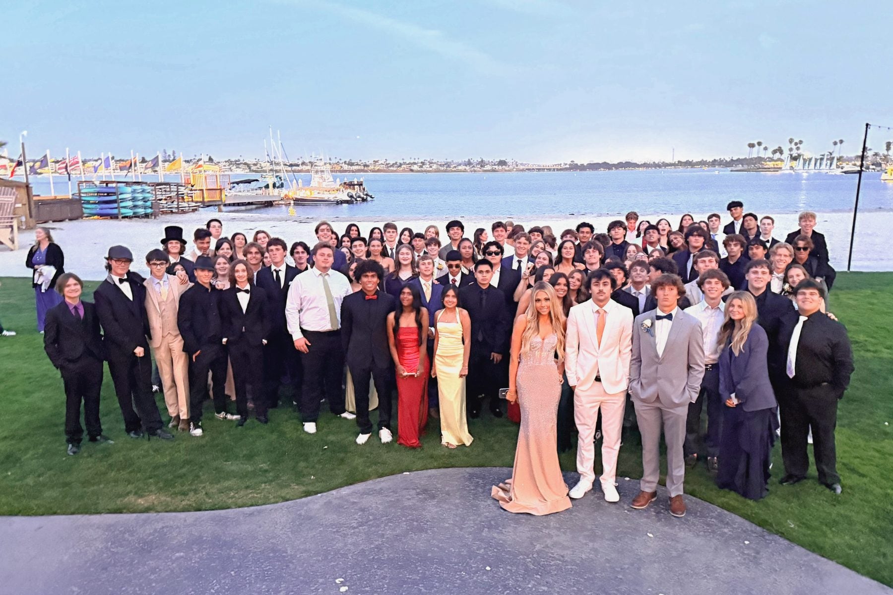 Christian High School Patriots students pose together outdoors near the bay