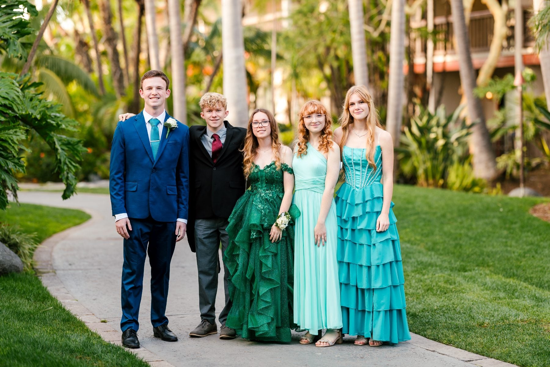 Five students in blue and green attire pose at Jr/Sr Banquet