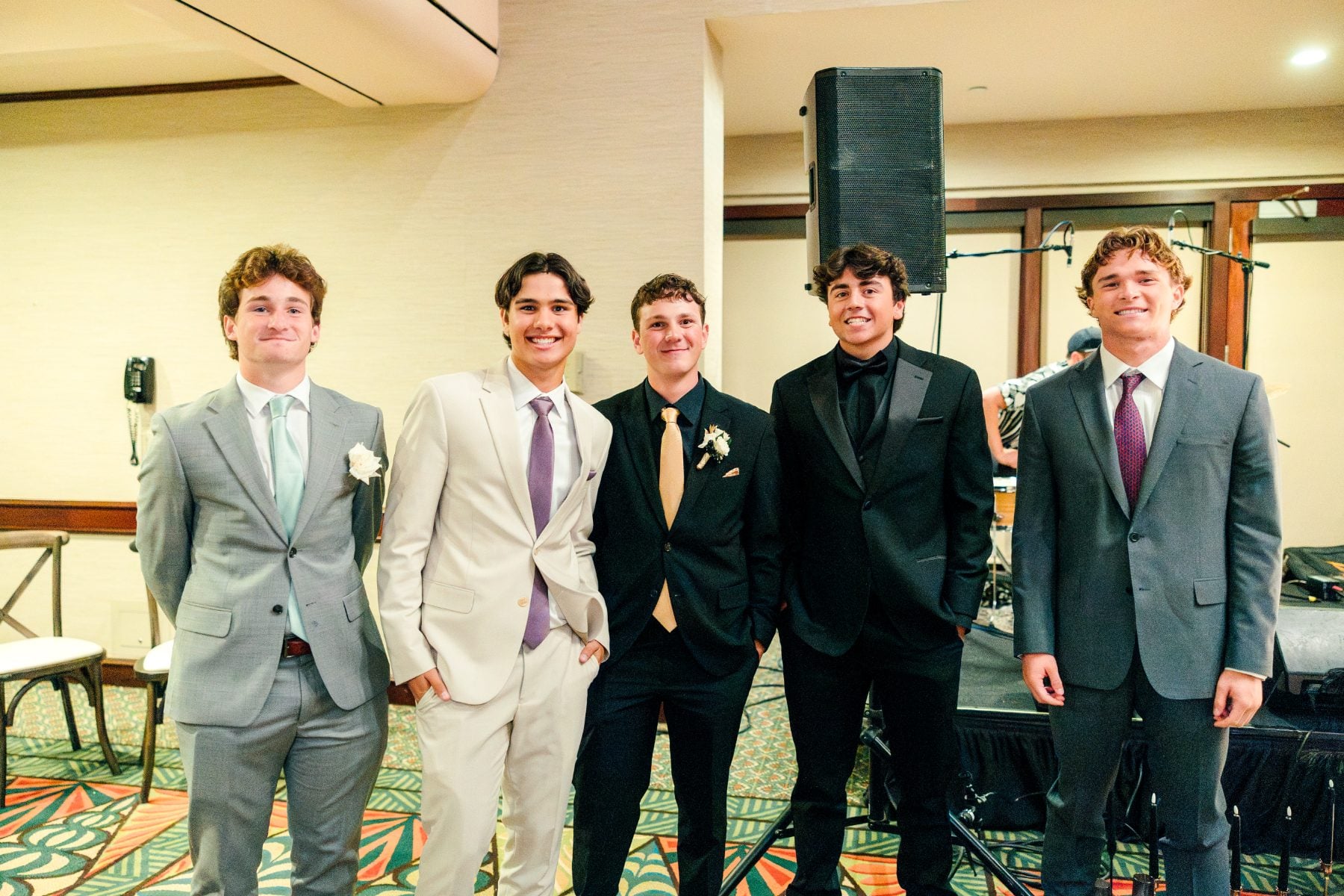 Five students in suits pose together at the Catamaran Resort banquet