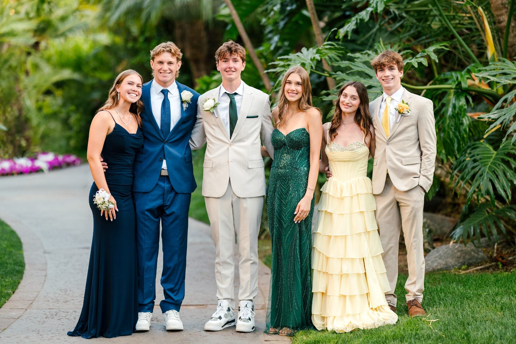 Six students in formal attire smile together at the Jr/Sr Banquet