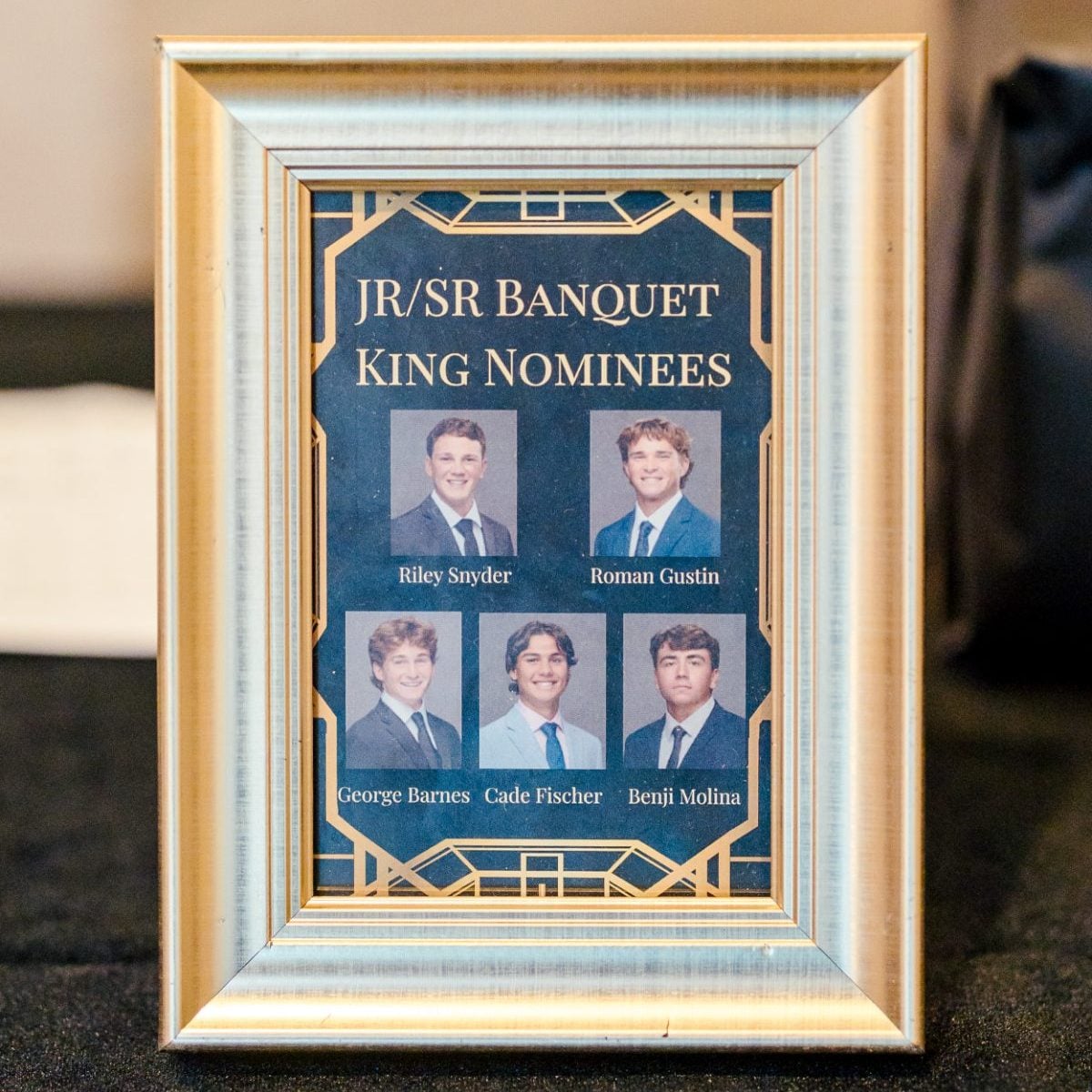 Framed list of Jr/Sr Banquet King Nominees displayed on event table