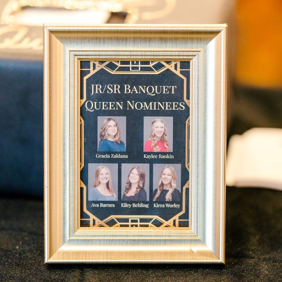 Framed list of Jr/Sr Banquet Queen Nominees displayed on event table