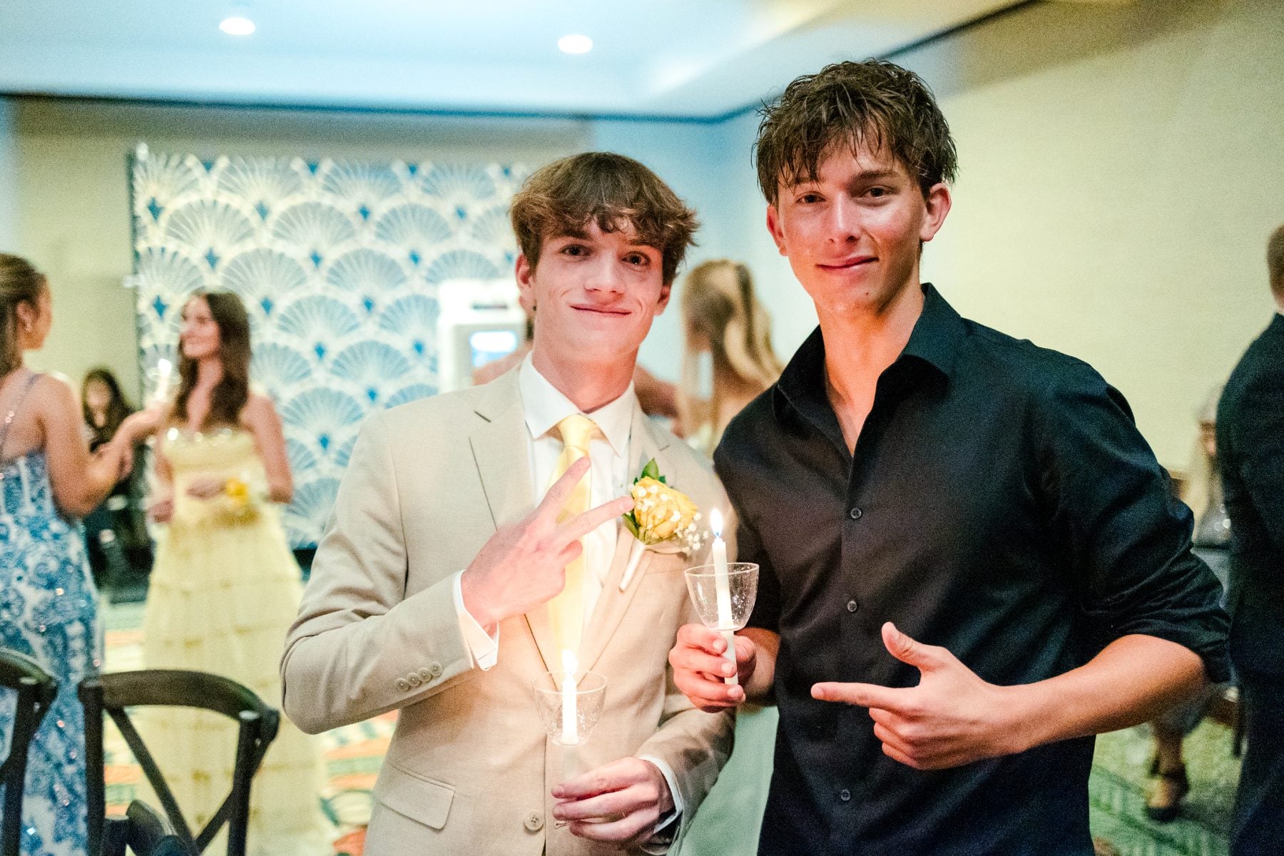 Two students share a laugh and toast at the Jr/Sr Banquet