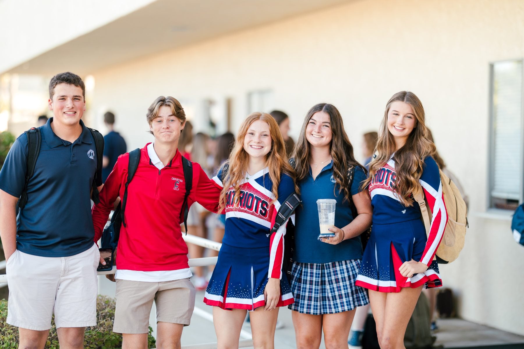 Patriots cheerleaders and students pose together on first day of school