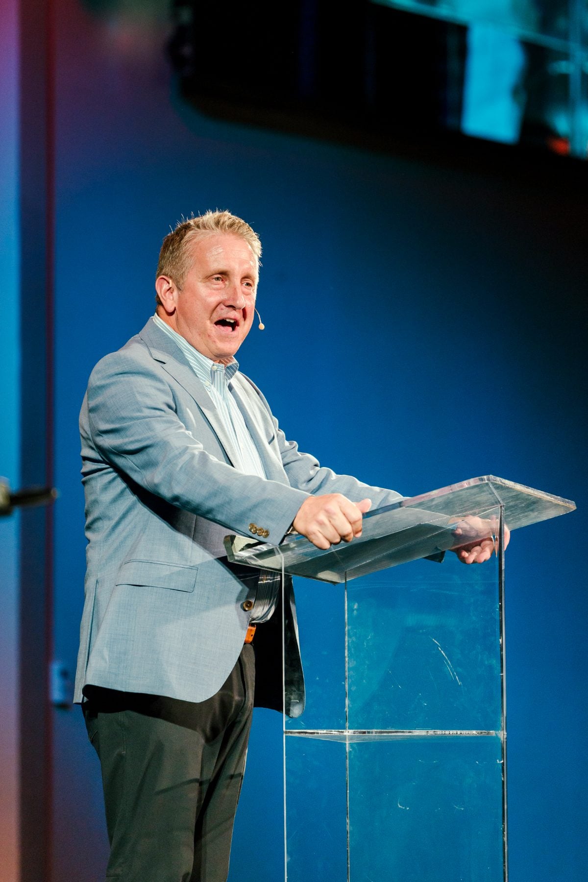 A speaker addresses students from the podium at Walk Worthy Chapel