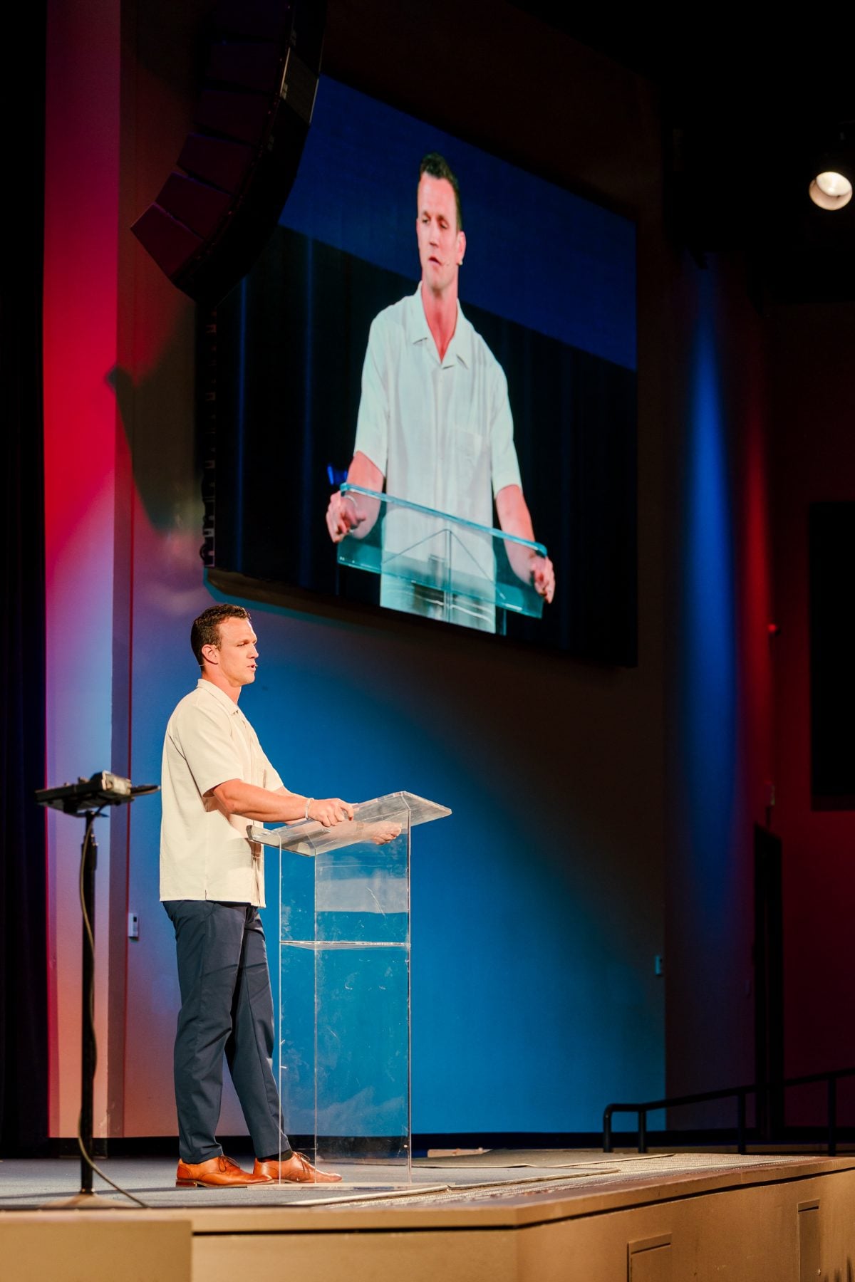 A speaker addressing students from the podium at the Event Center chapel