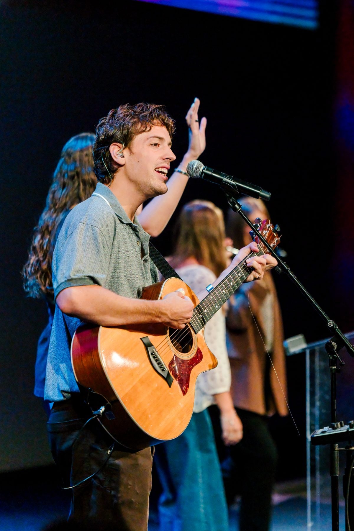 A student leads worship on guitar during the Walk Worthy chapel service