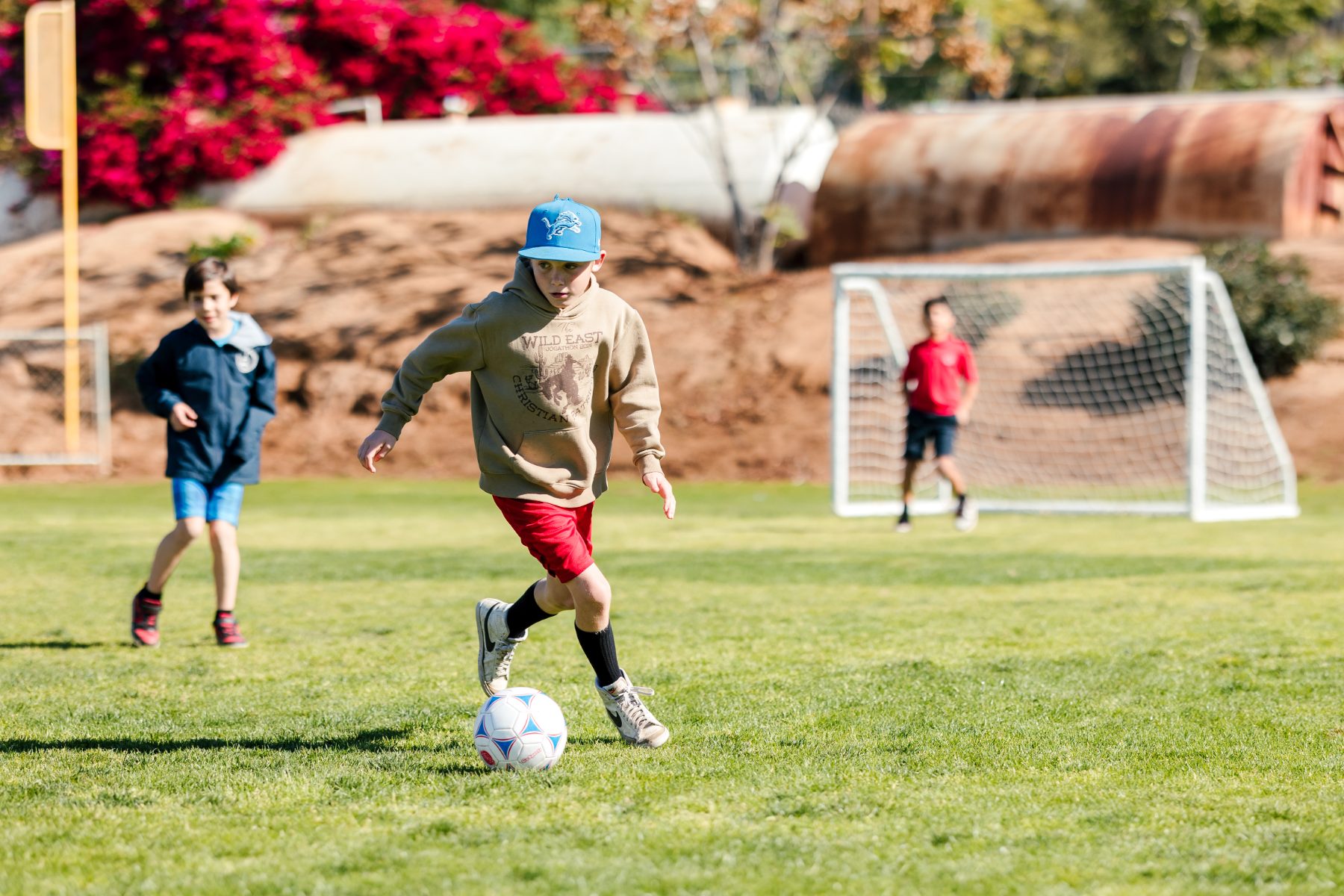 A student dribbles a soccer ball during recess at Christian Elementary