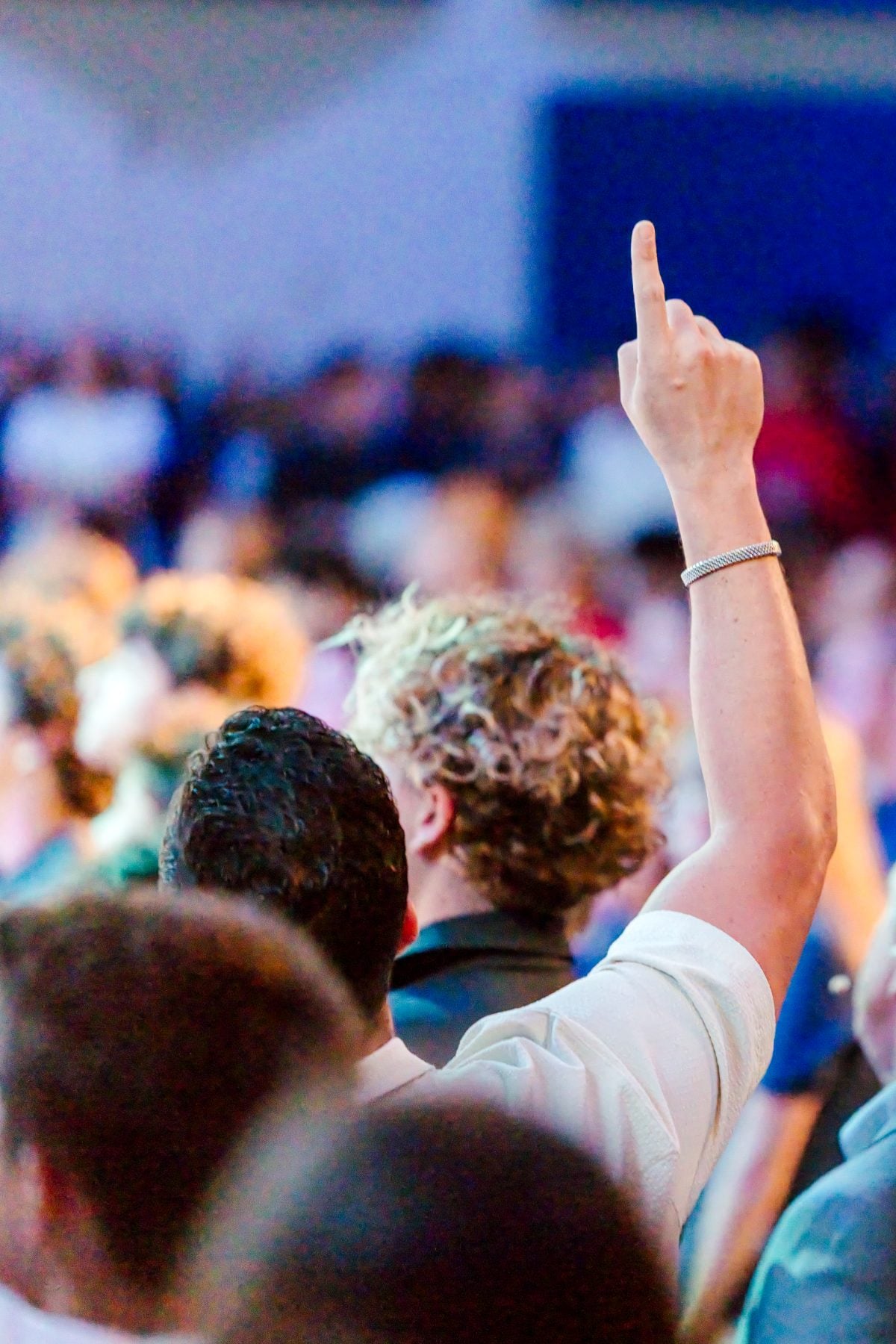A student raises his hand during worship at the chapel kick-off