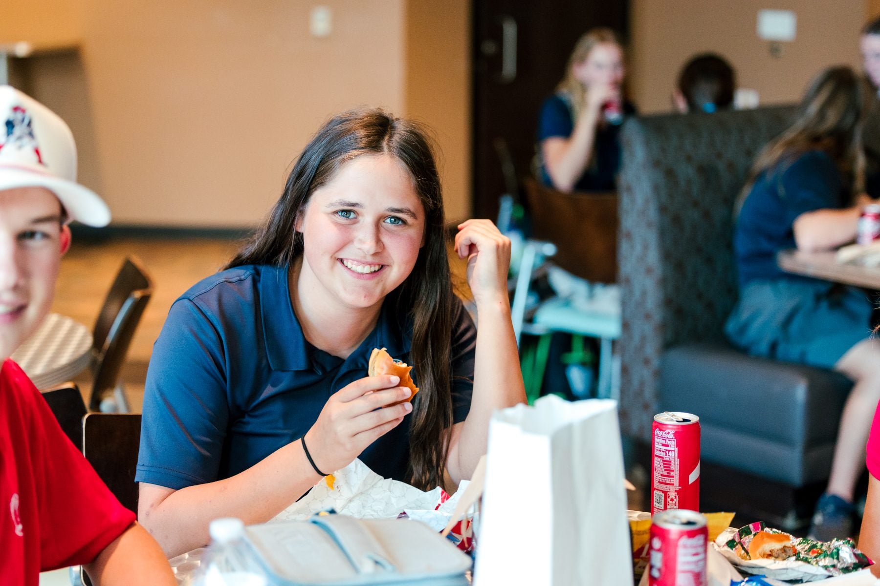 A student gives a thumbs up while eating at the BBQ kickoff