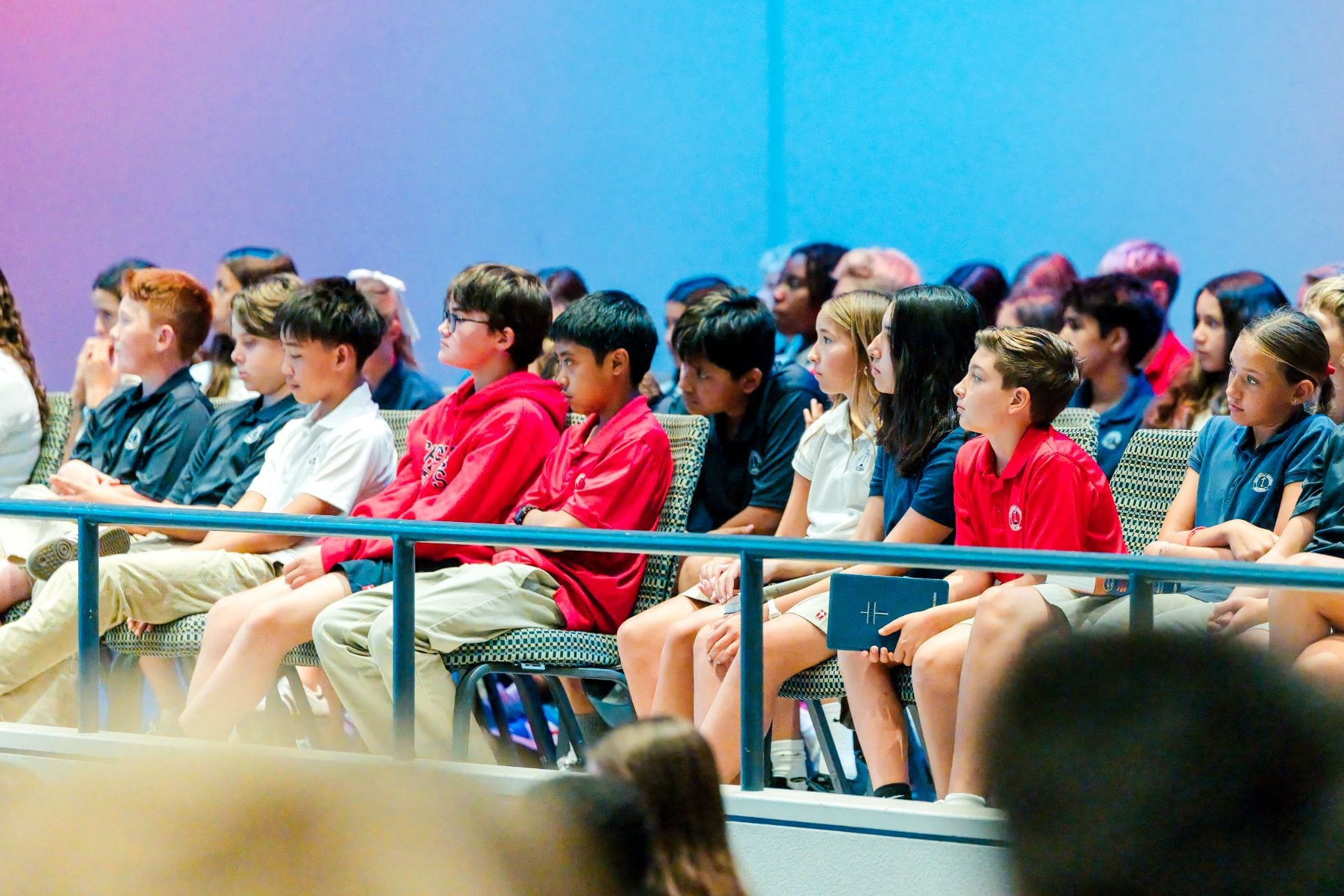 Students sit together listening during chapel at the Event Center