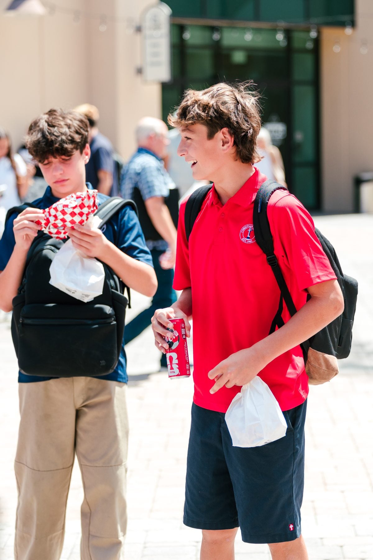 Two students holding food and a soda at the Walk Worthy BBQ kick-off