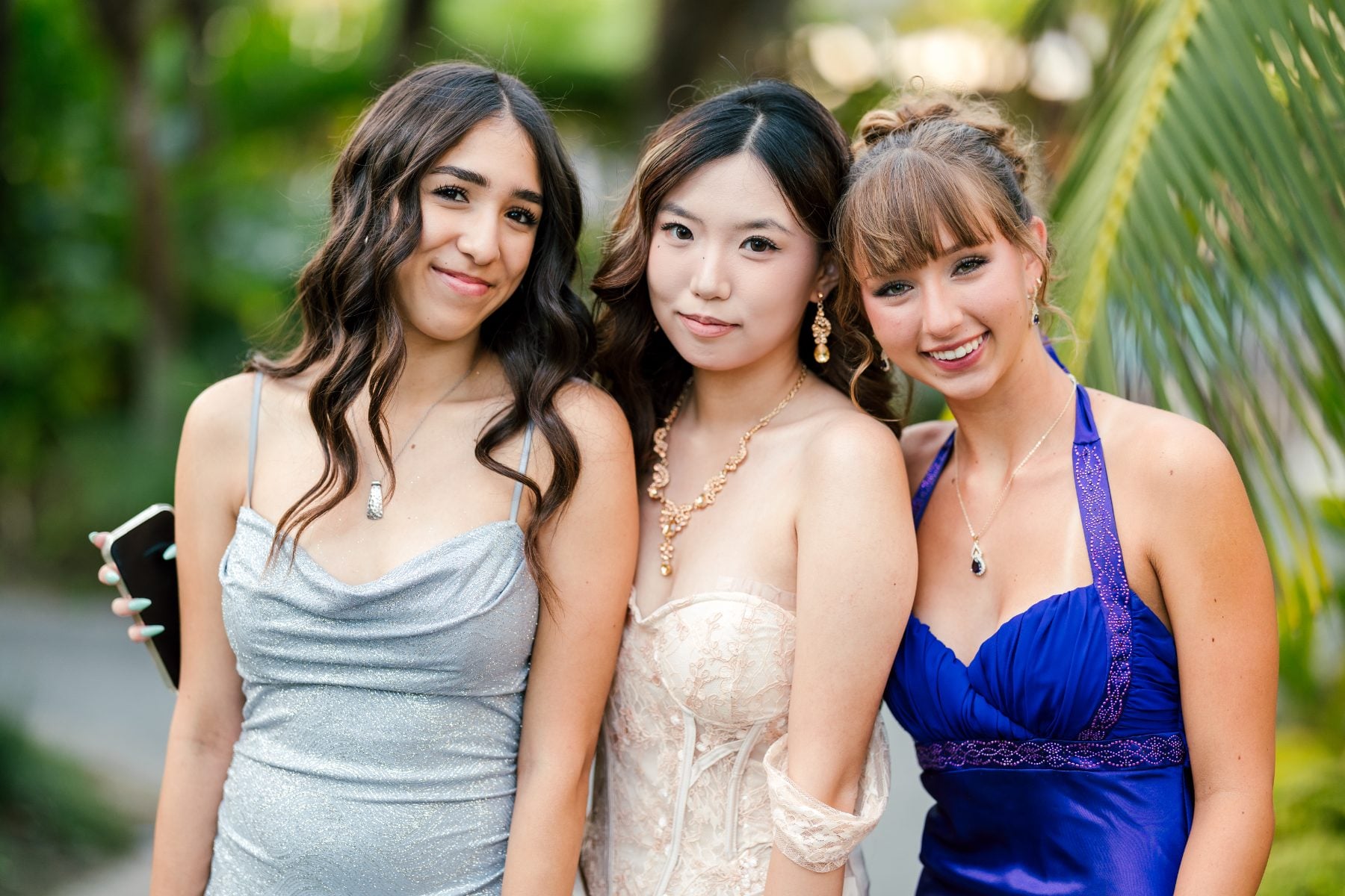 Three students pose outdoors at Christian Unified Schools Jr/Sr Banquet