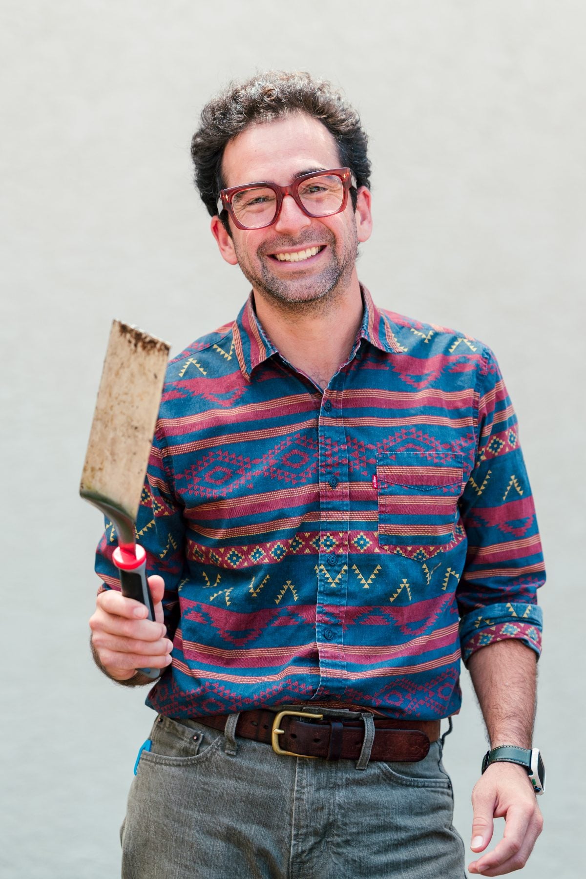 A teacher holds a rustic spatula at the Walk Worthy Chapel Kick-off BBQ