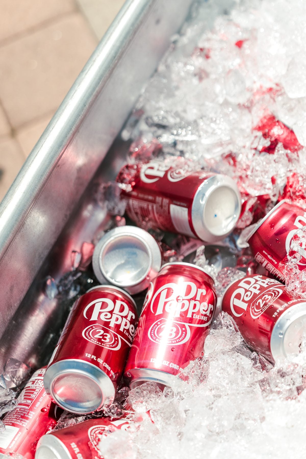 Dr Pepper and Coke cans chilling on ice at the BBQ kick-off