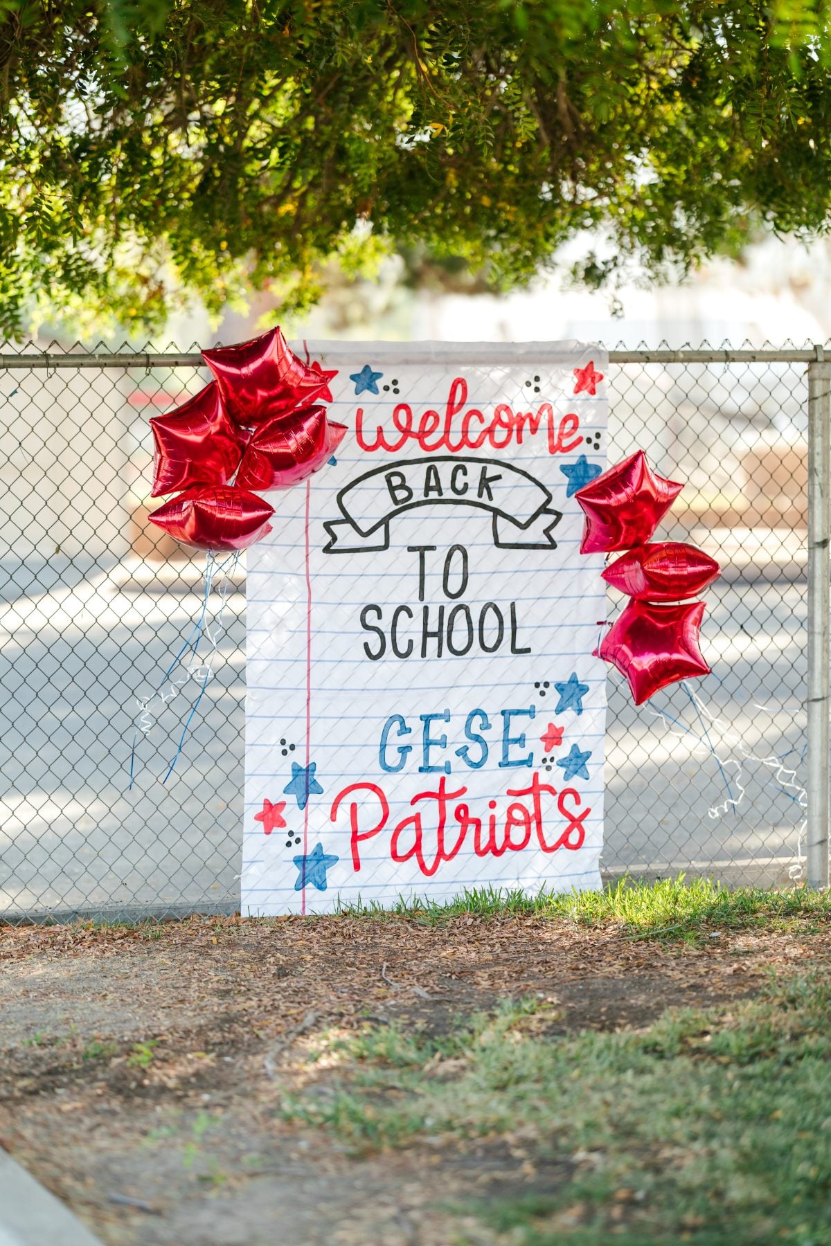 A welcome back to school sign with red balloons greets CUSD Patriots