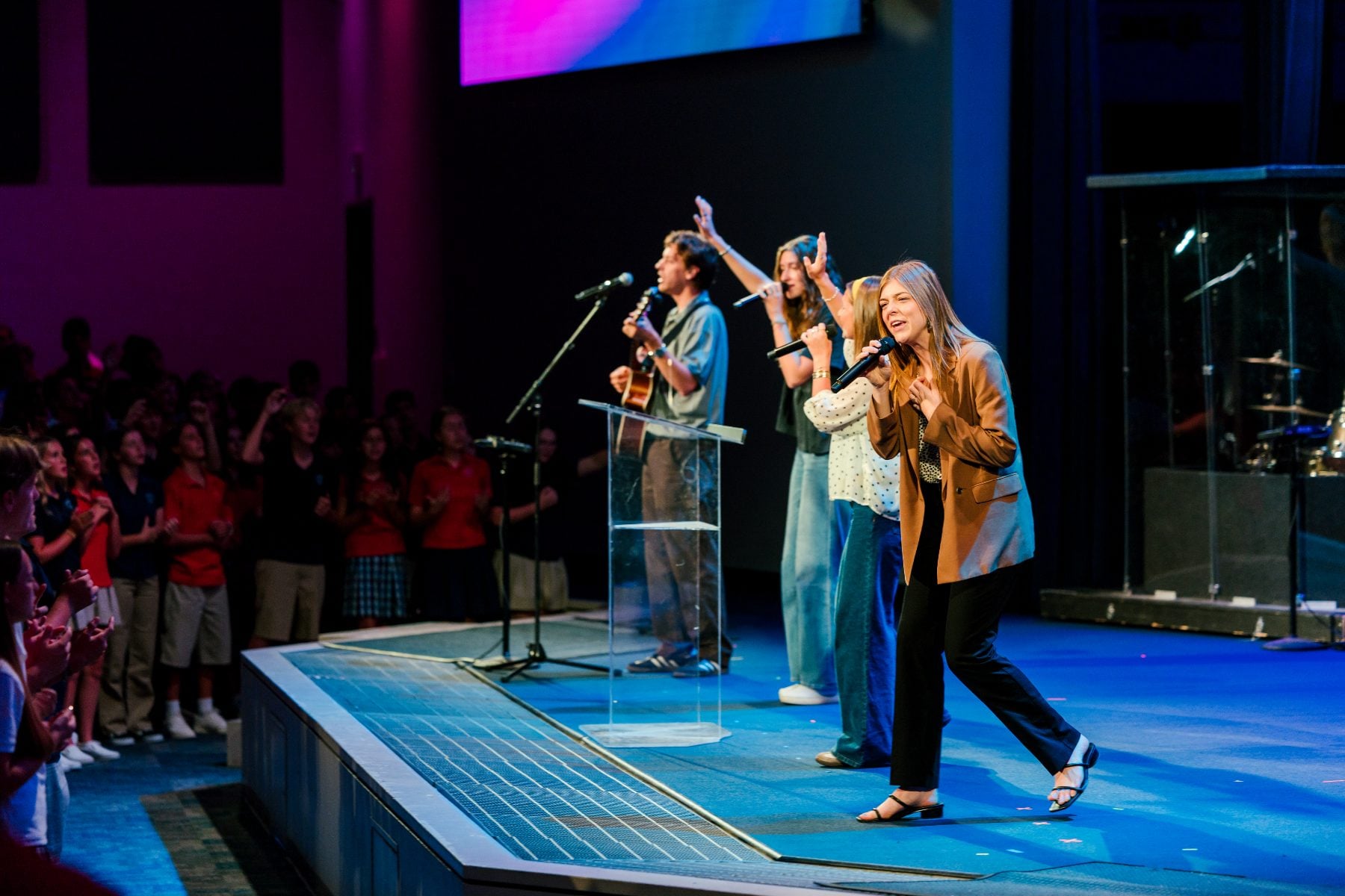 Worship leaders sing on stage during the Walk Worthy Chapel kickoff