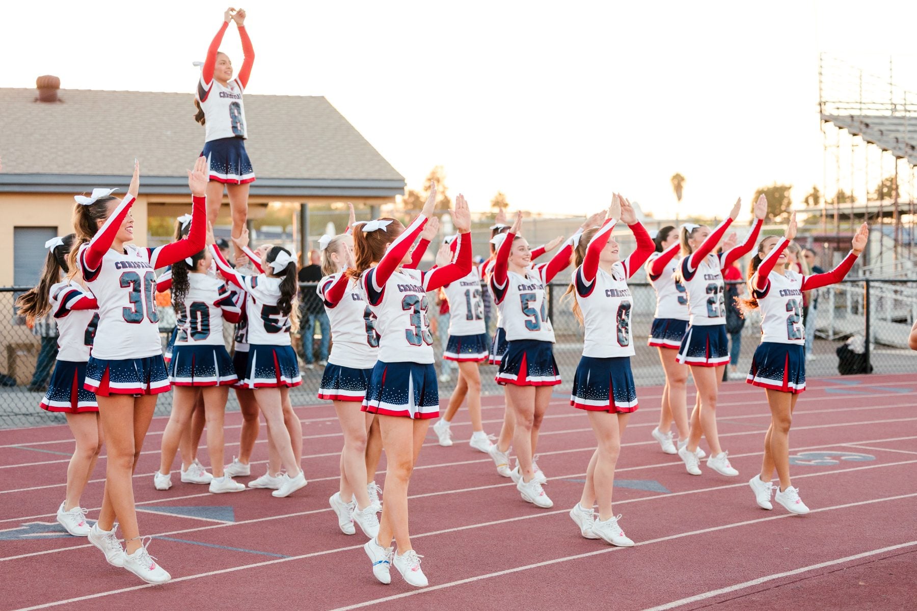 Patriots cheer squad lifts a teammate high during a homecoming stunt