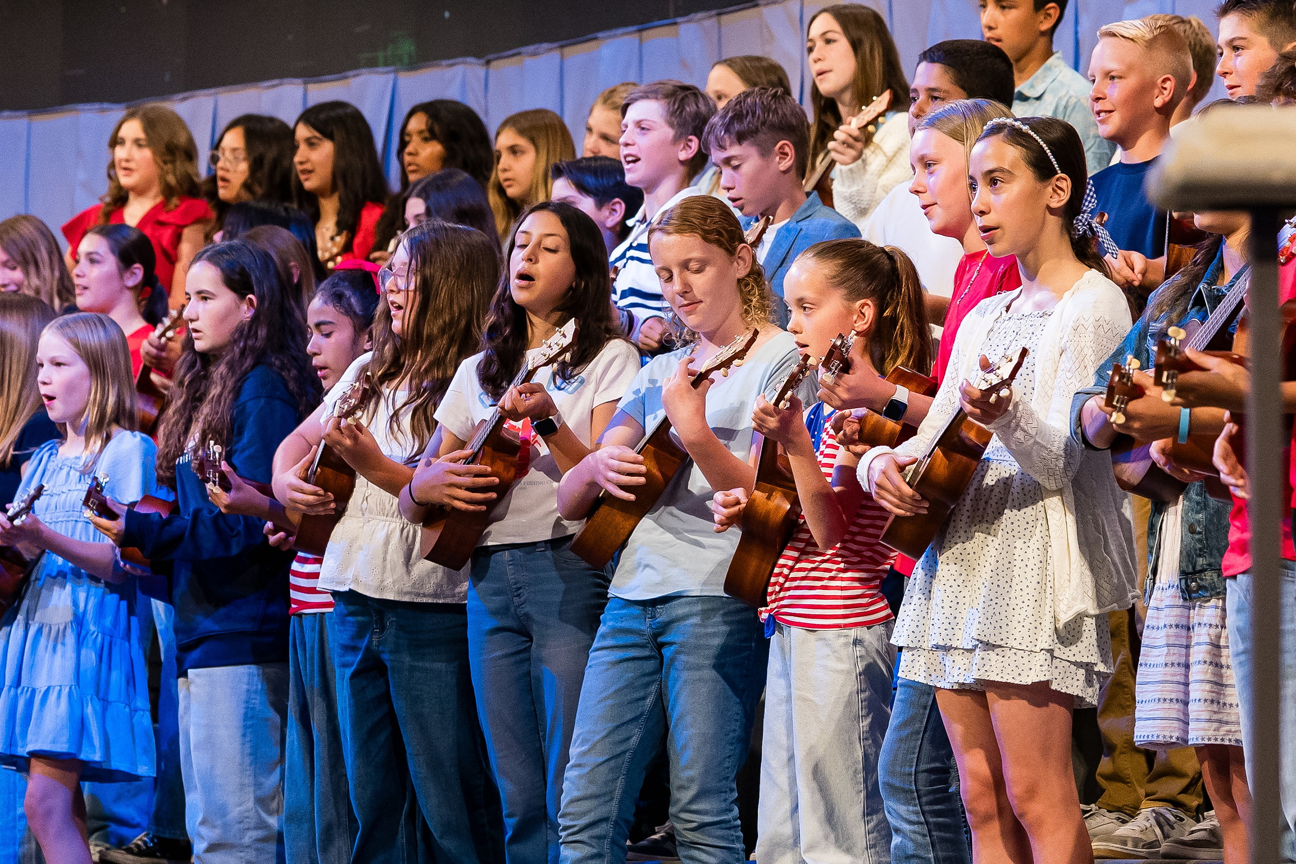 Christian Elementary East Celebrates Spring with “One Nation Under God” — 04 Group of elementary students singing and playing ukuleles during performance