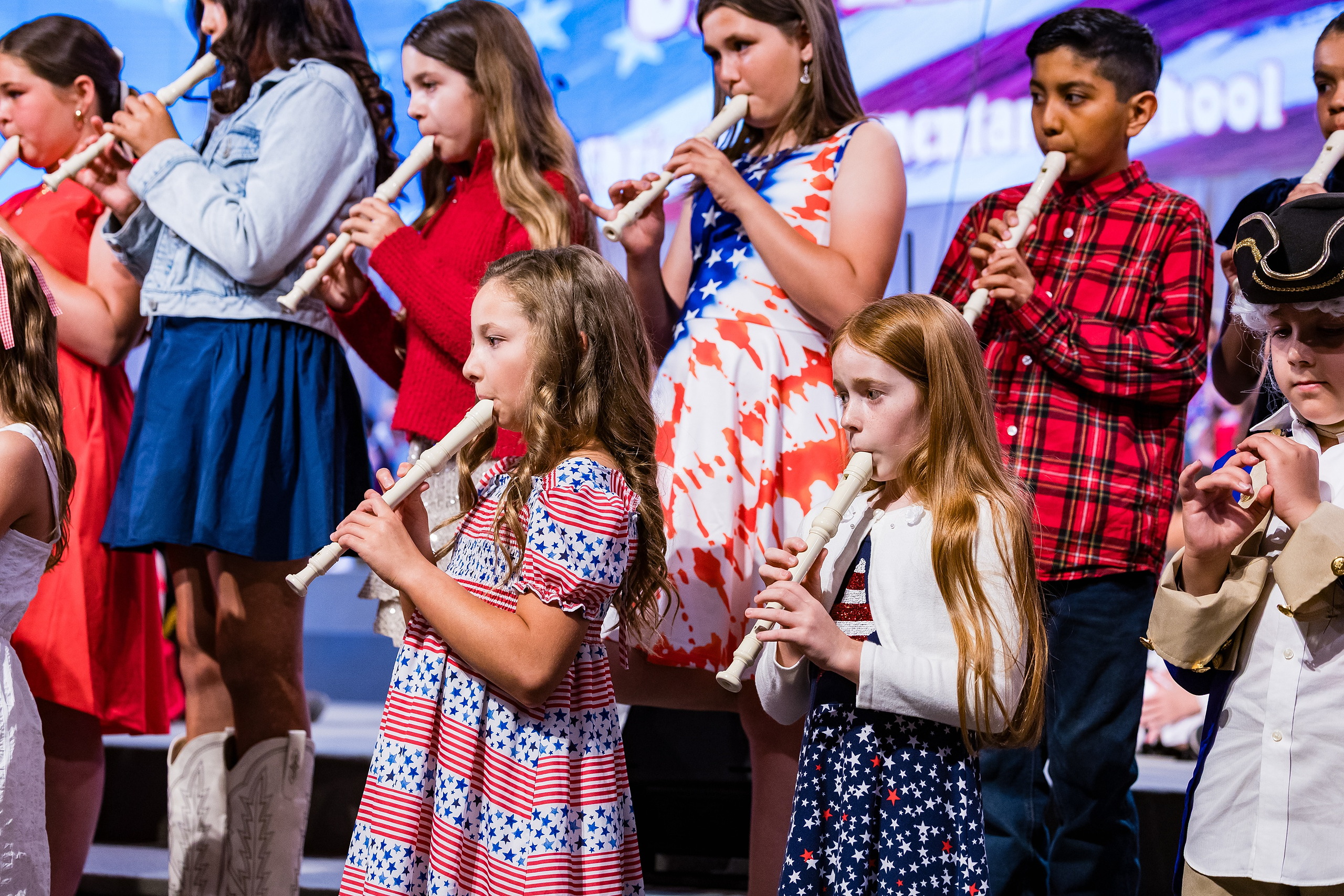 Christian Elementary East Celebrates Spring with “One Nation Under God” — 09 Group of young students performing with flute and recorder instruments