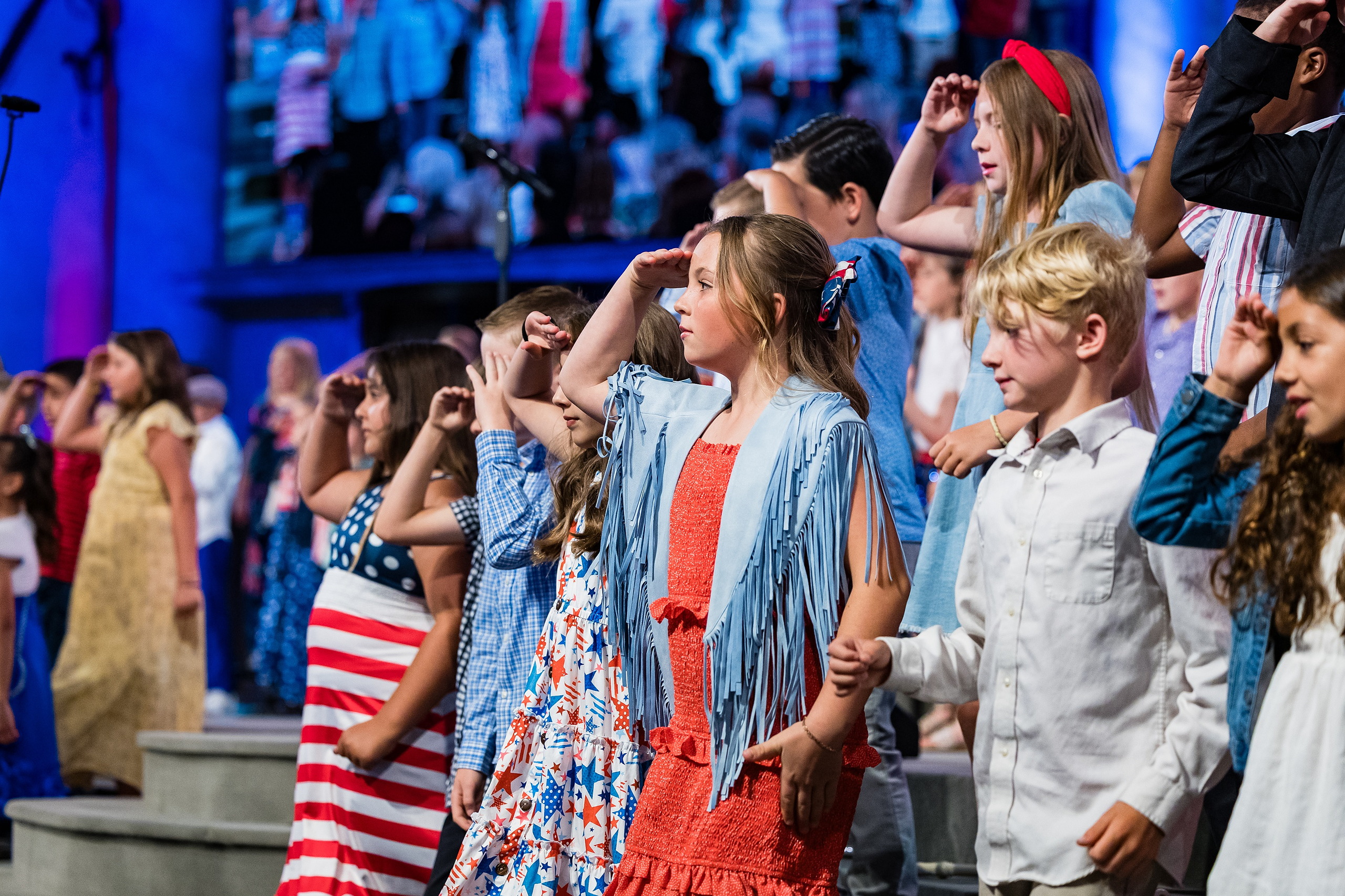 Christian Elementary East Celebrates Spring with “One Nation Under God” — 12 Group of students dancing with hands raised during celebration number