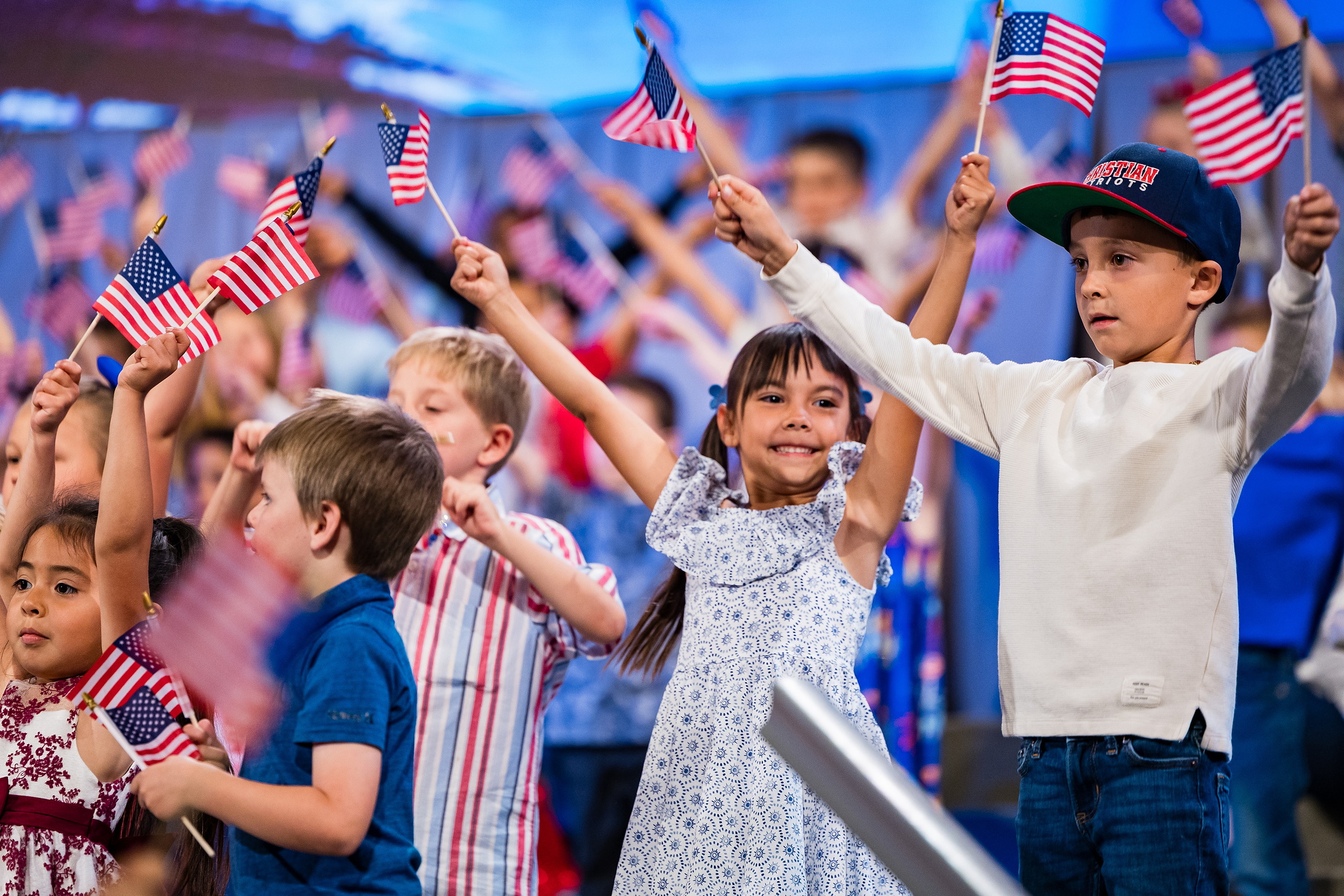 Christian Elementary East Celebrates Spring with “One Nation Under God” — 19 Young children enthusiastically waving American flags during celebration
