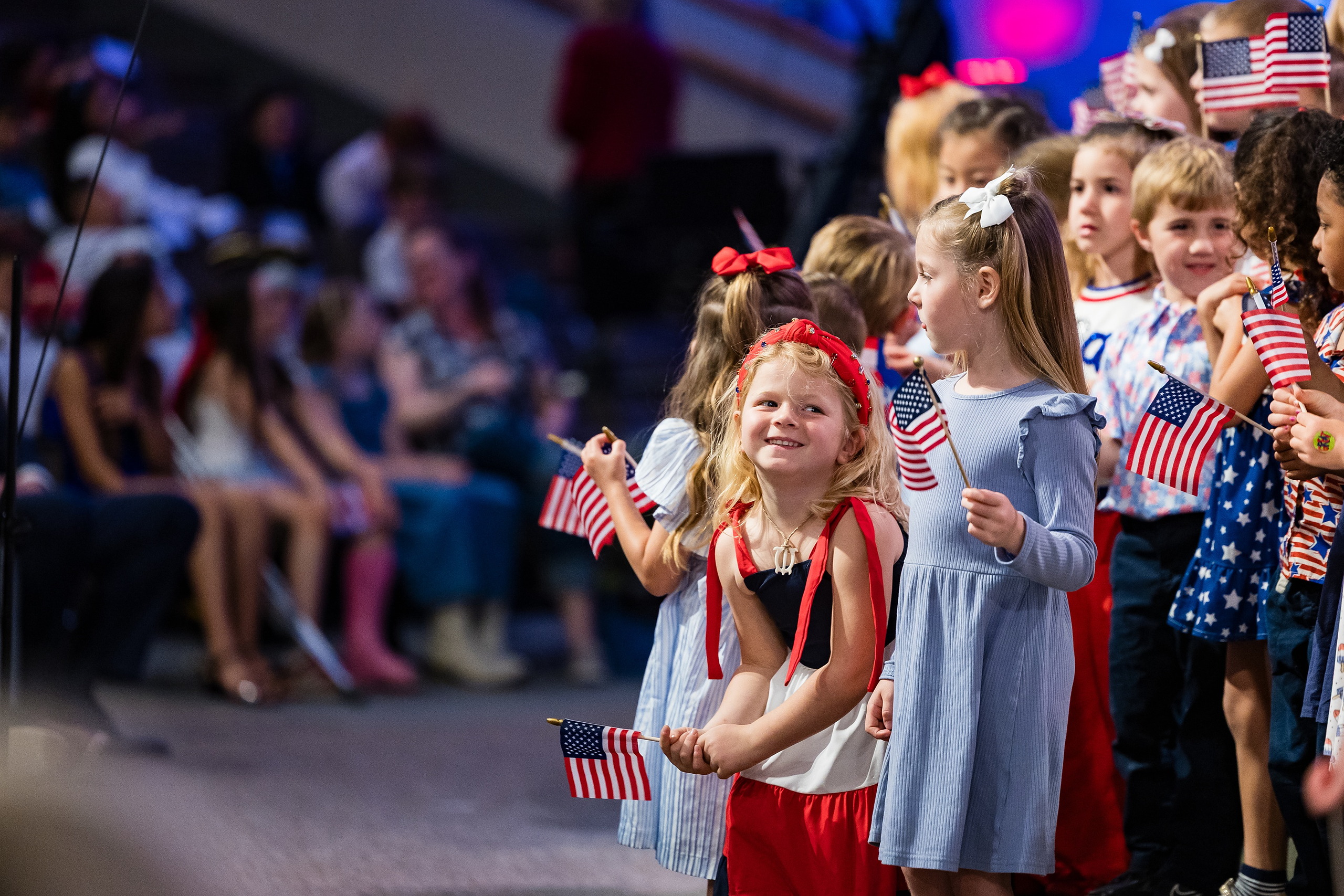 Christian Elementary East Celebrates Spring with “One Nation Under God” — 24 Group of smiling elementary students holding American flags