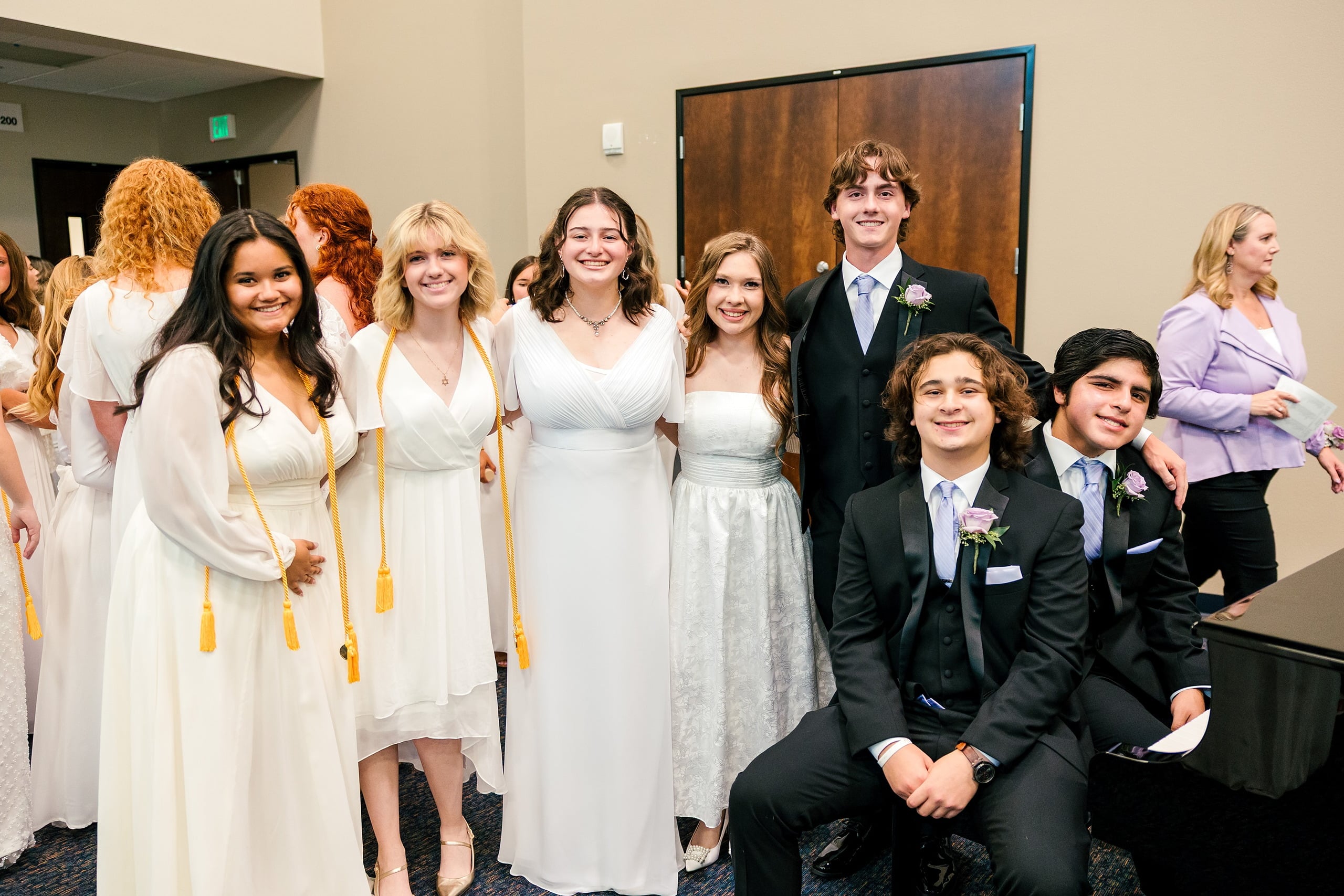 Christian High School Commencement 2025: Rise Up — 01 Graduates in formal white and black attire stand together at Christian High School Commencement