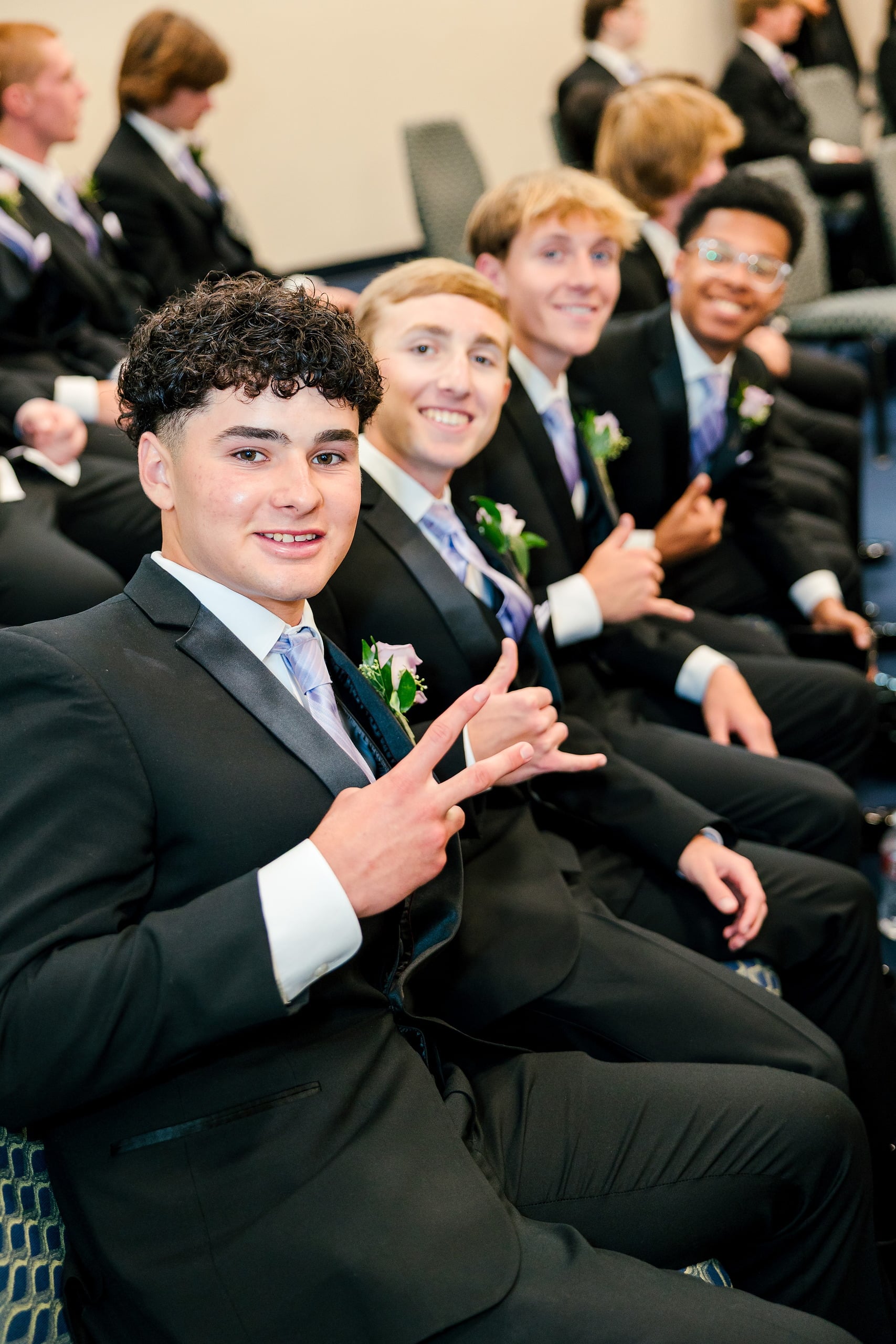 Christian High School Commencement 2025: Rise Up — 08 Male graduate gives thumbs up to the camera while seated at the ceremony