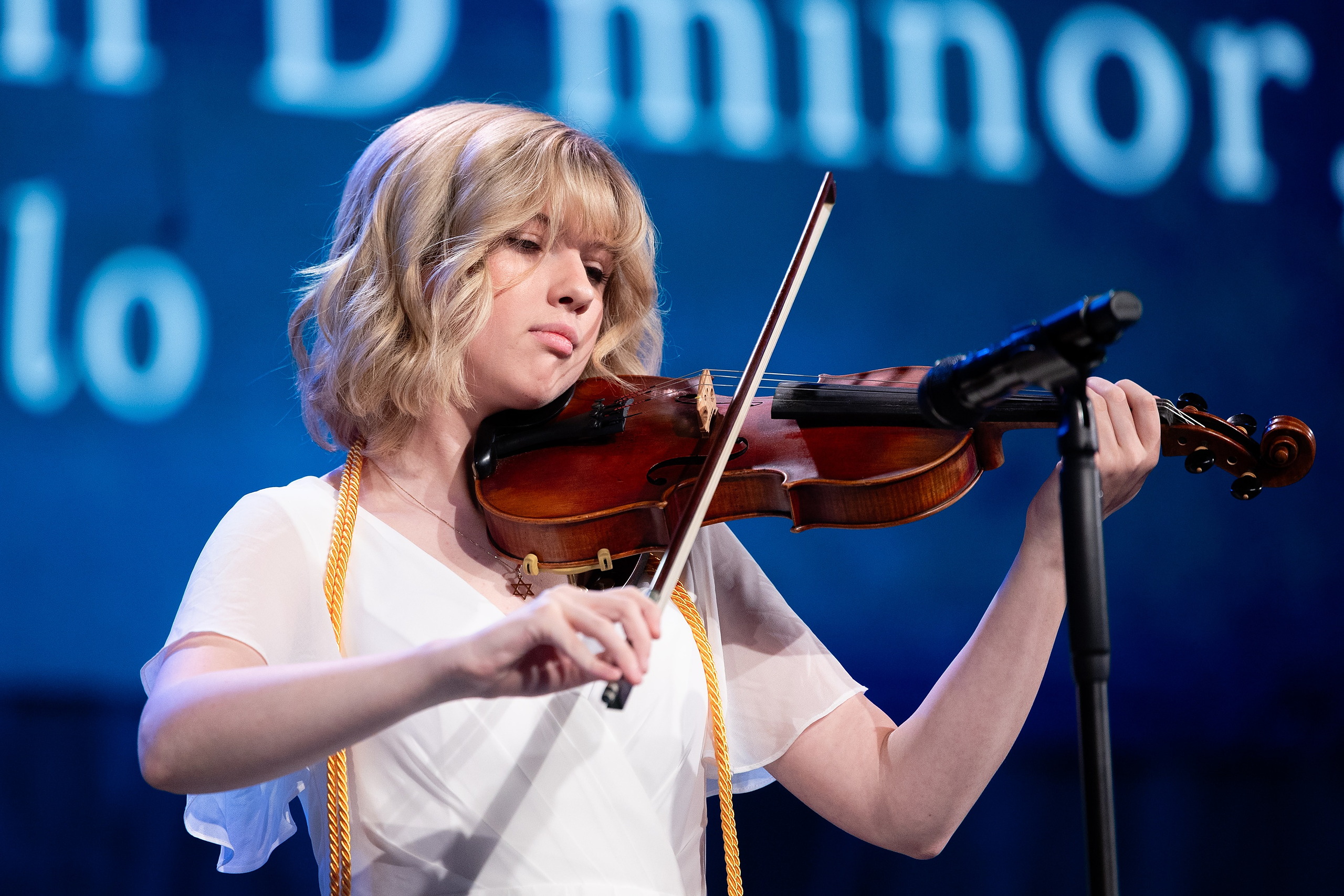 Christian High School Commencement 2025: Rise Up — 13 Female graduate plays violin while performing during the commencement ceremony