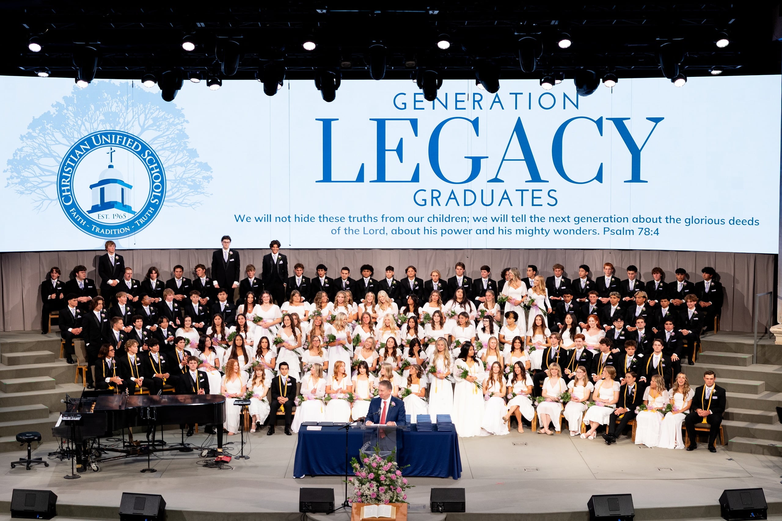 Christian High School Commencement 2025: Rise Up — 21 Legacy graduates and classmates gather on stage during the commencement program