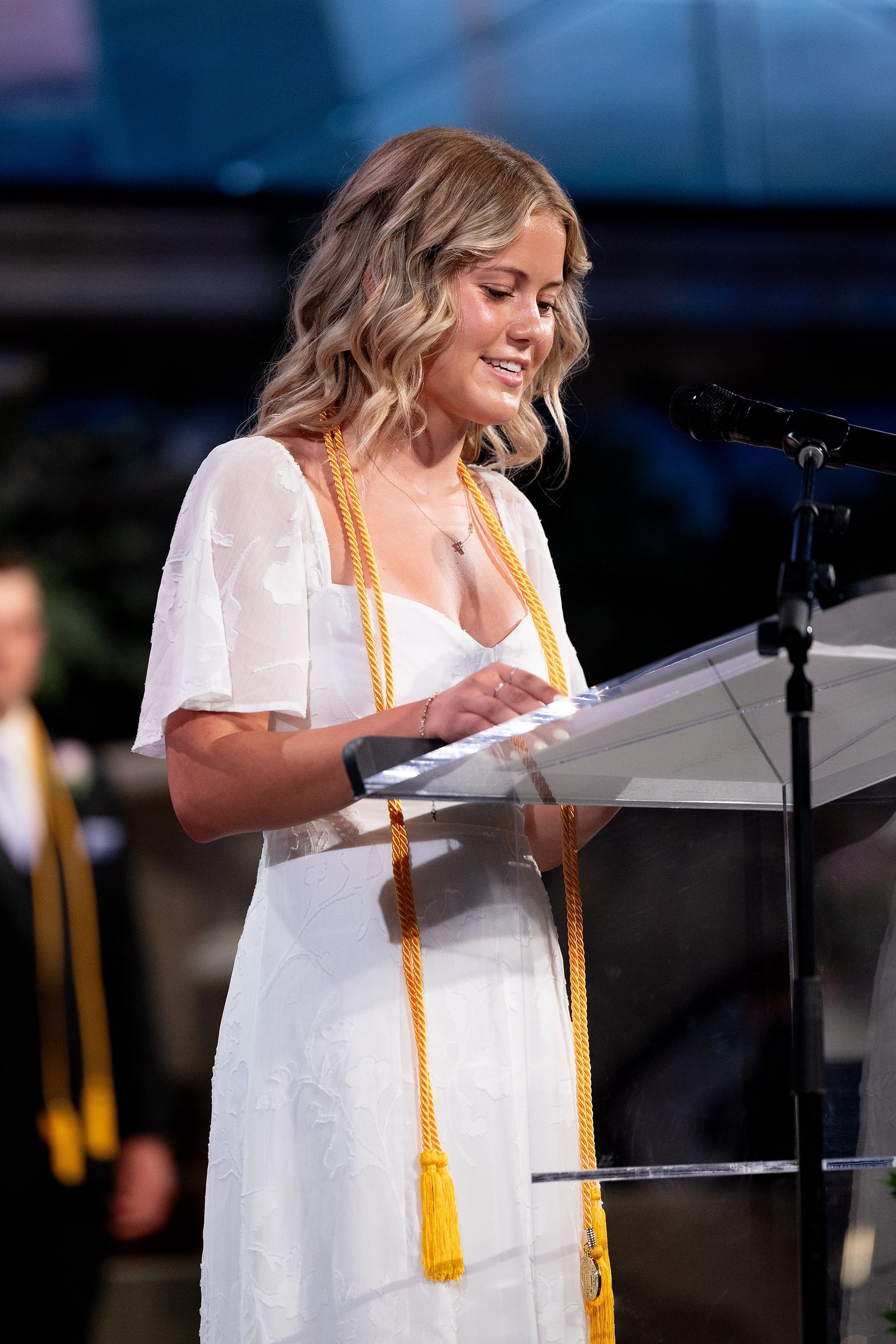 Christian High School Commencement 2025: Rise Up — 23 Female graduate in white dress delivers remarks from the podium