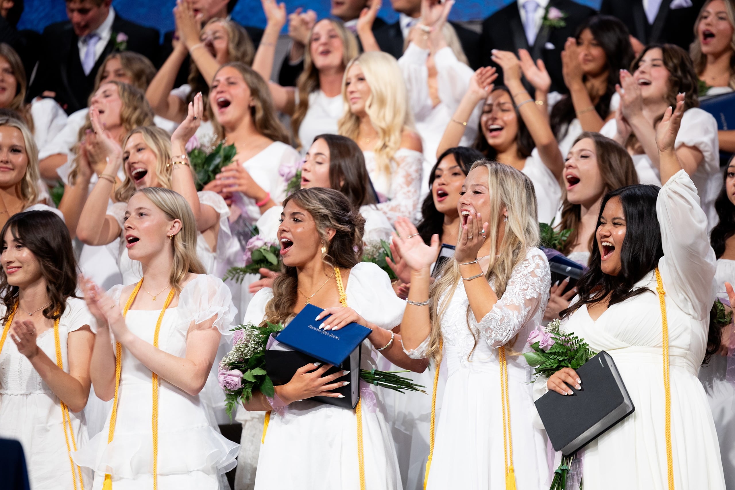 Christian High School Commencement 2025: Rise Up — 40 Female graduates smile broadly while celebrating at commencement conclusion