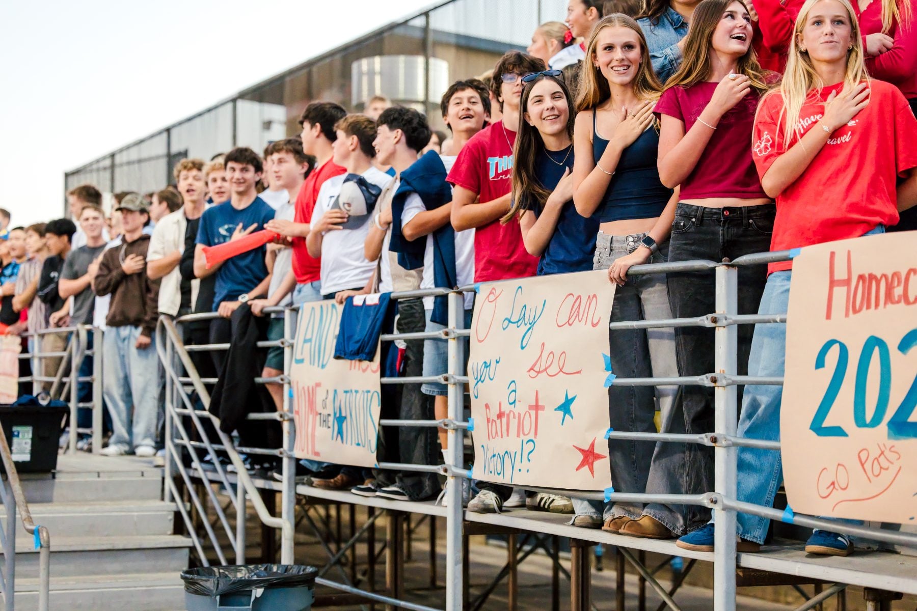Fans in the stands place hands over hearts during the anthem