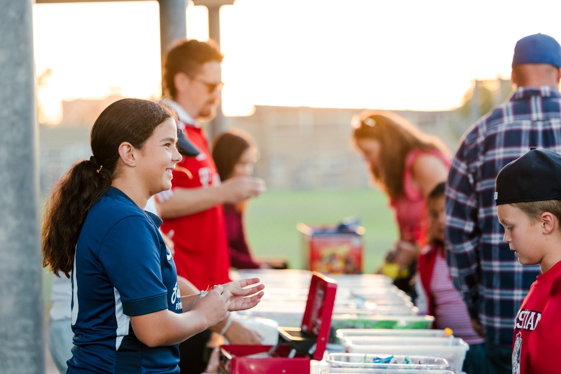 A student helps at a table during a Christian Unified Schools campus event