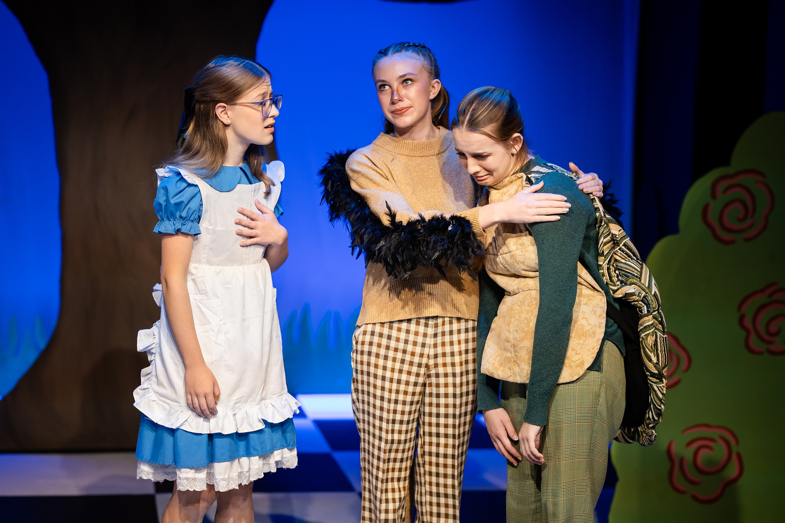Curiouser and Curiouser! A Whimsical Journey with the Patriot Players — 06 Three cast members perform together: Alice, Duchess, and character in green