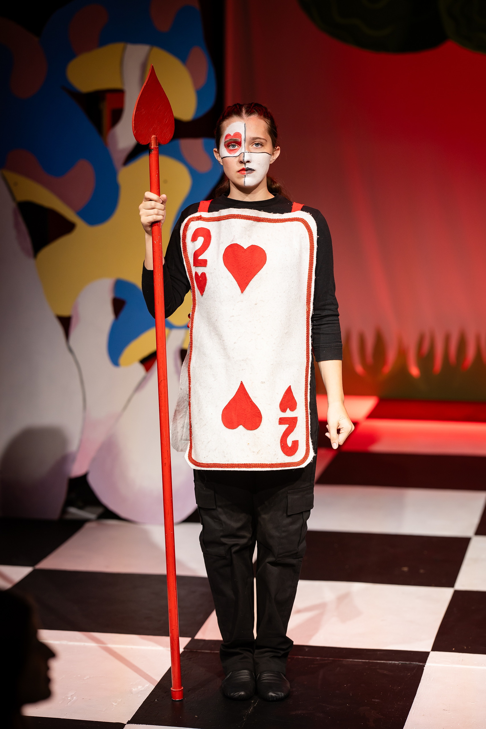 Curiouser and Curiouser! A Whimsical Journey with the Patriot Players — 08 Queen of Hearts in red and white card costume holds red staff