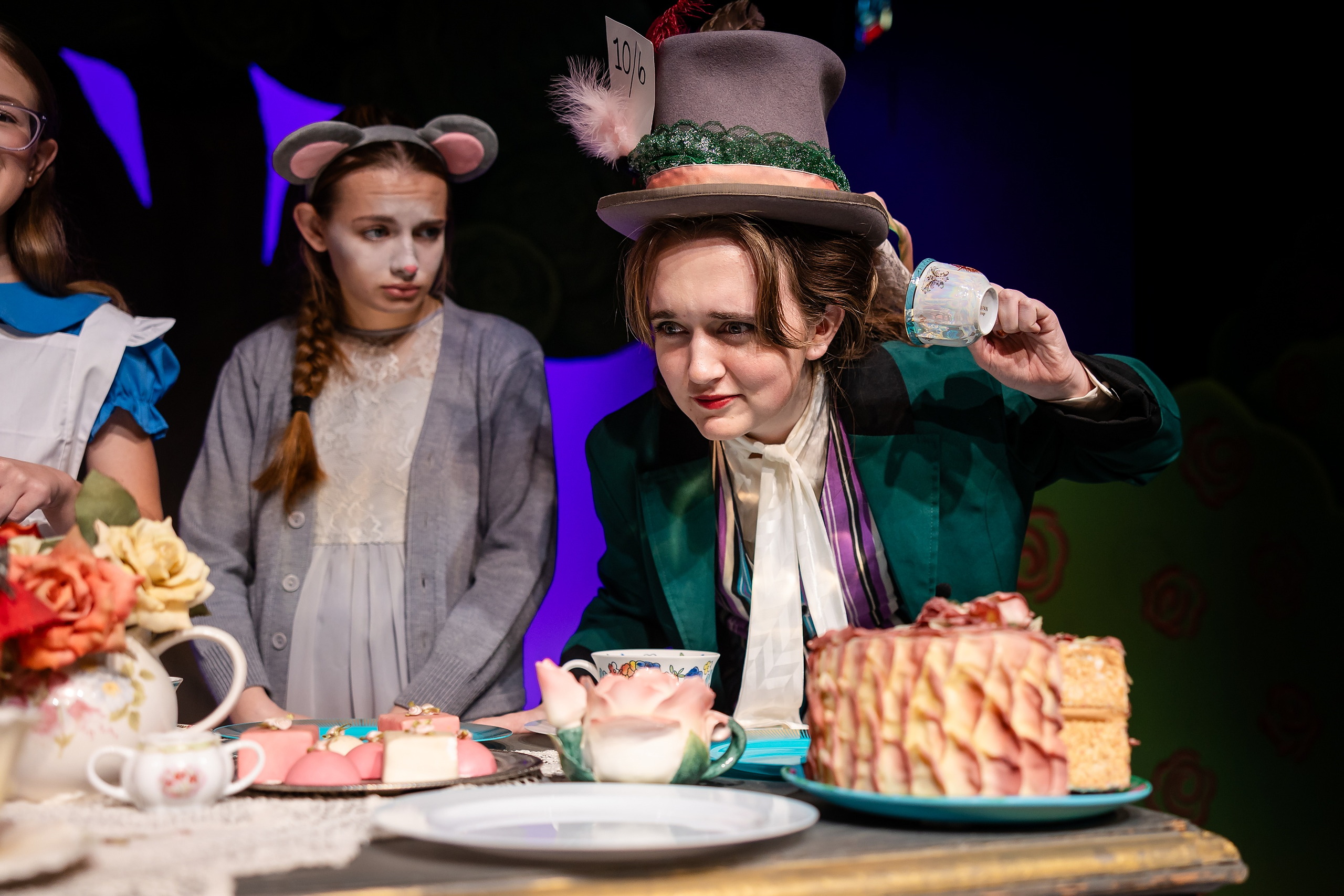 Curiouser and Curiouser! A Whimsical Journey with the Patriot Players — 13 Three students perform Mad Hatter tea party scene in costume