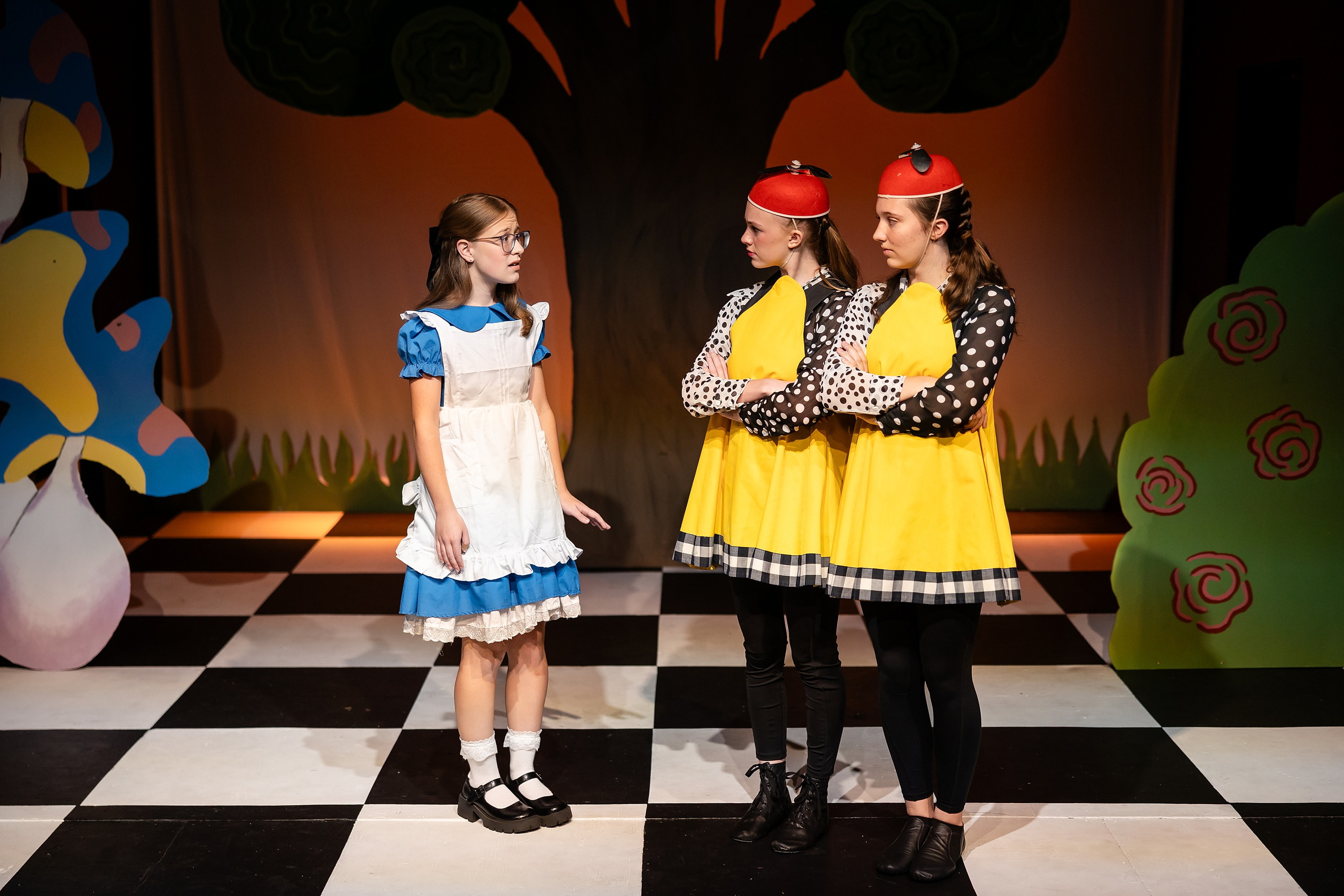 Curiouser and Curiouser! A Whimsical Journey with the Patriot Players — 14 Alice confronts two Tweedle characters in yellow polka dot costumes