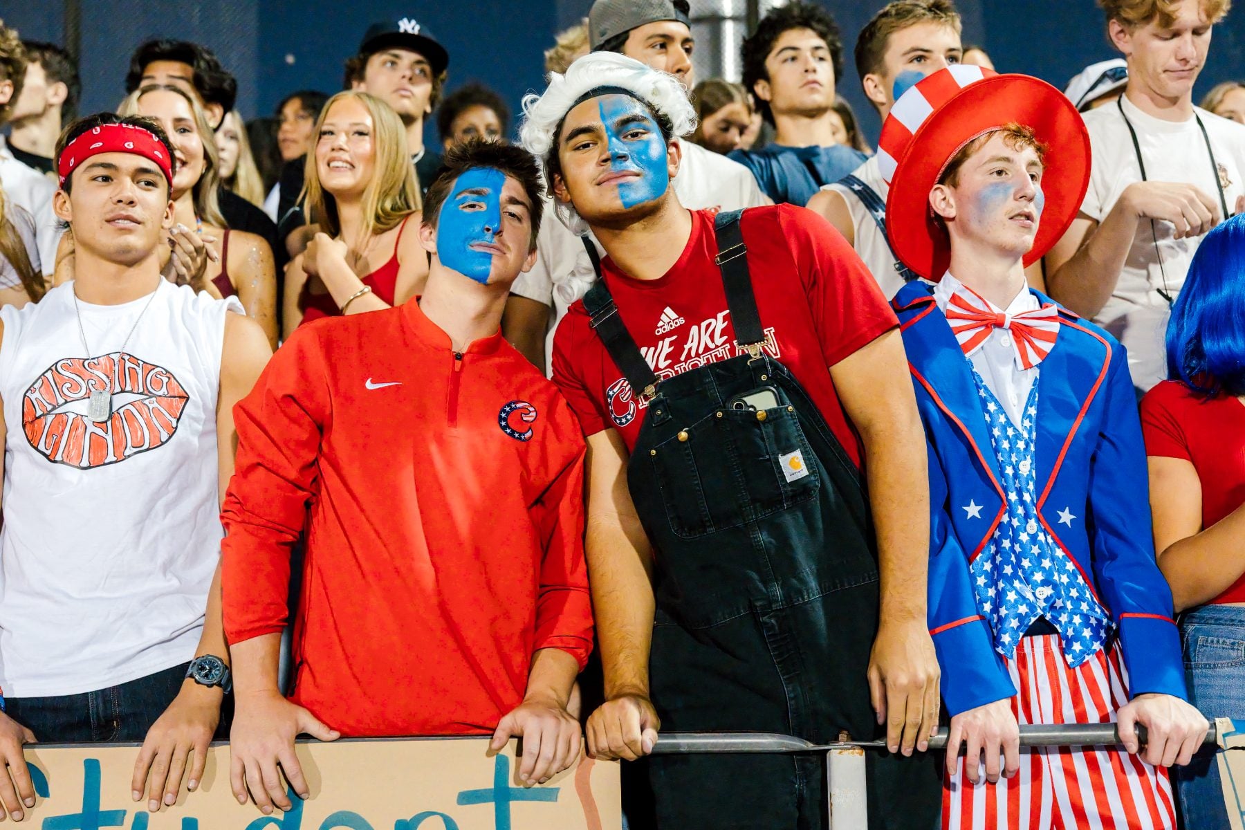 Students in patriotic costumes stand together in the bleachers at El Cajon Valley