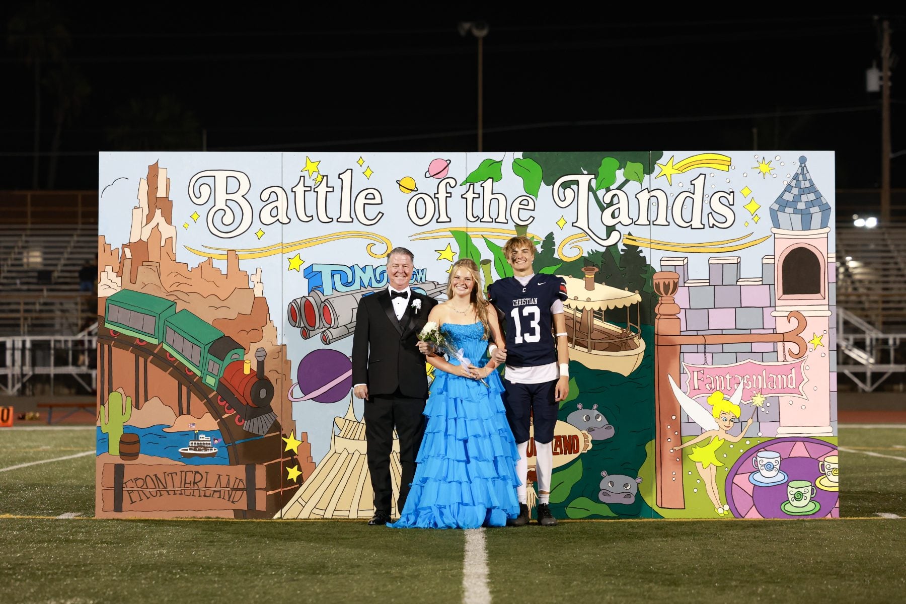 Homecoming court poses together, player in blue jersey number 13