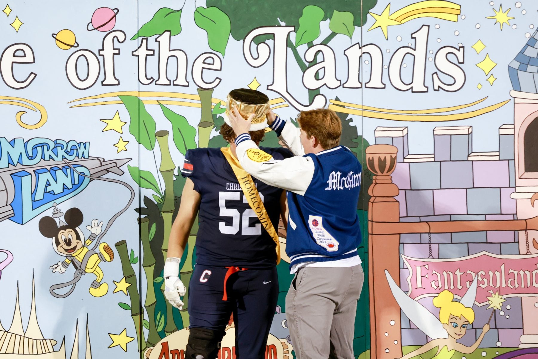 A student places a crown on a football player at Christian High School
