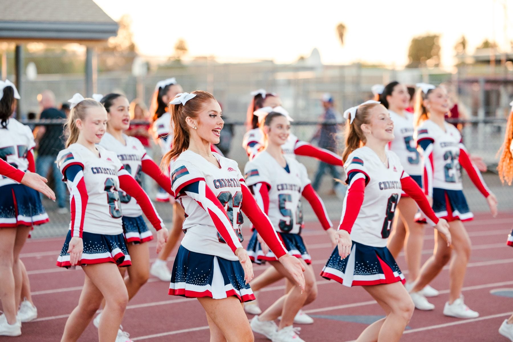Christian High School Patriots cheerleaders perform on the track during homecoming