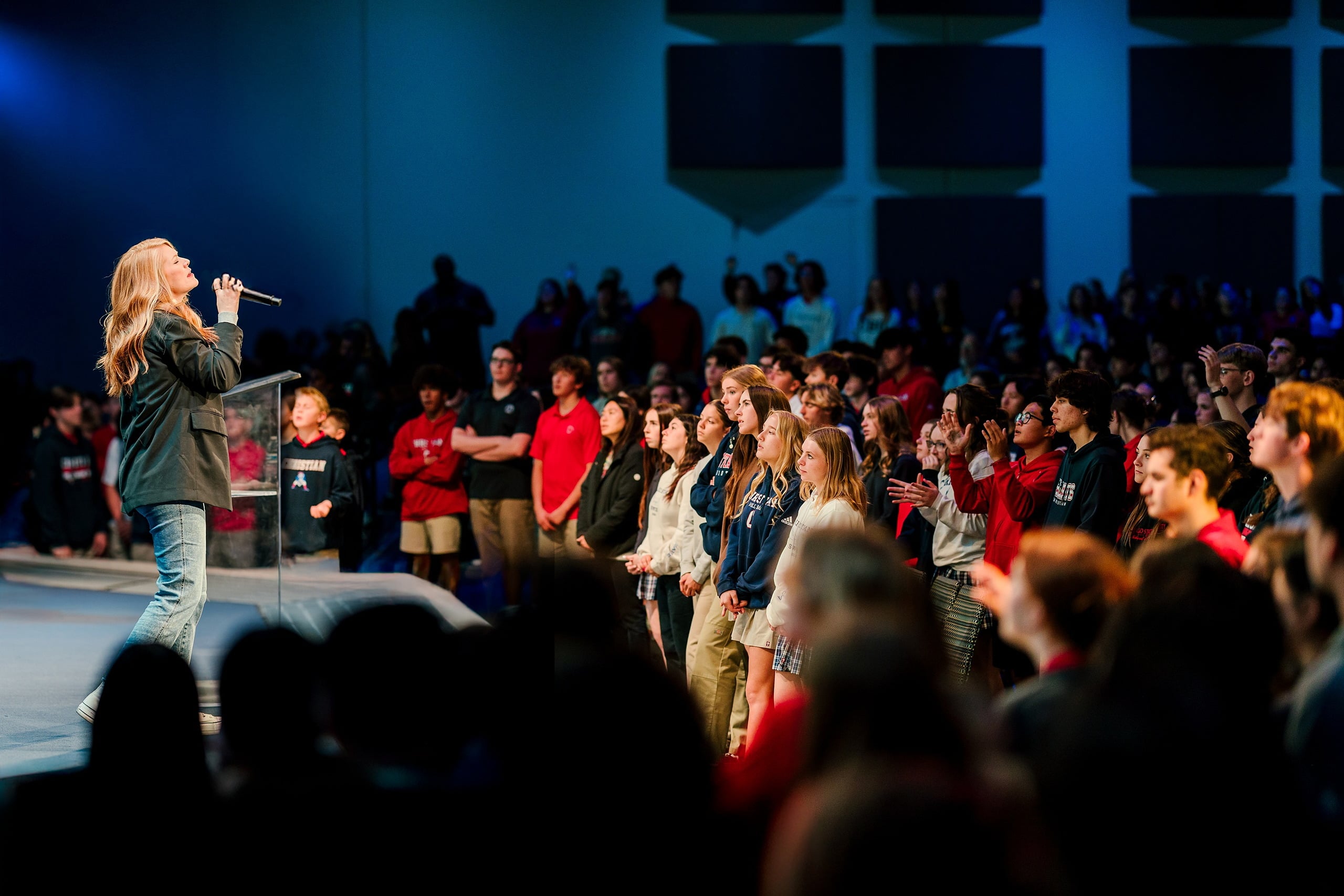 Spiritual Emphasis Week 2025 — 04 Speaker gestures while addressing assembled high school students in chapel